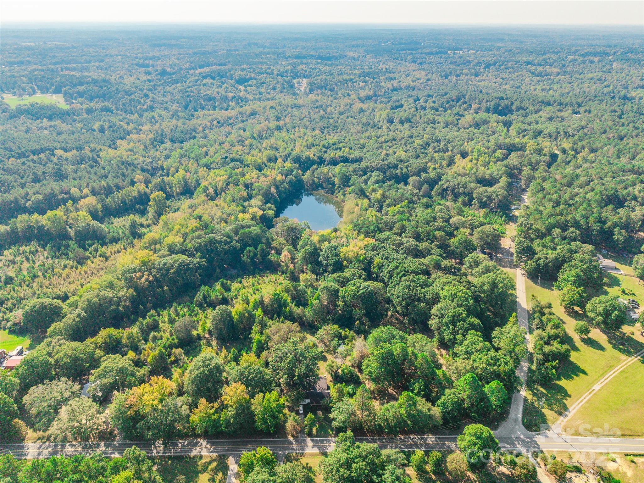 54 of 56 acres being sold with 3 dwellings at no value.  Great for developers! Main home is habitable, but in poor condition.