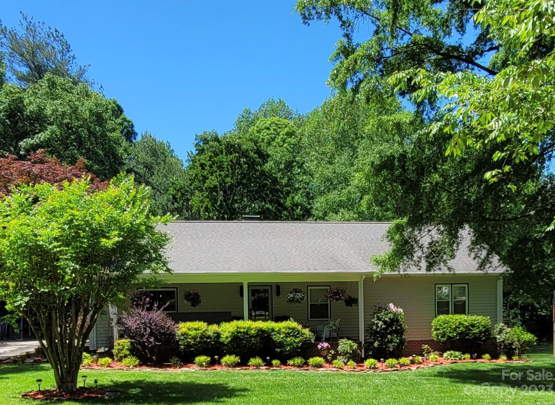 This charming one level home is nestled in a cul-de-sac surrounded by matured trees & lush landscape. An open layout kitchen flows into the dining & living area with hard wood floors throughout the main area of the home. Newly remodeled master bathroom, walk in master closet, and new flooring in bedrooms are just some of the highlights you'll find inside. Wood burning fireplace in the living room. Outside you'll find a brand new large deck overlooking the backyard. Ample parking with a flat driveway, two car garage, and main level laundry make this a great home for those looking for easy, turn-key living.
