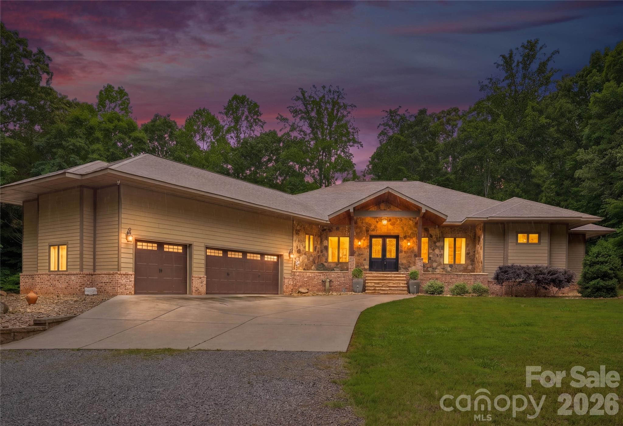 Welcome to 9860 Harvest Lane—an exceptional private retreat tucked away at the end of a quiet lane on 12.37 wooded acres, perfectly positioned between Mooresville, Davidson, Huntersville and Concord. Built in 2018, this custom home offers over 3,100 square feet of refined luxury living, plus an additional 3,100 square feet of unfinished basement space ready to be transformed into a recreation area, workshop, fitness studio, guest quarters, or ultimate storage for outdoor gear and equipment.  

Designed with both comfort and entertaining in mind, the open-concept floor plan features a gourmet kitchen with a butler’s pantry, a spacious great room with a stunning stone fireplace, and a luxurious primary suite complete with its own stone fireplace, spa-inspired bath, and dual walk-in closets. Two additional bedrooms, two full baths, a private office, and a spacious laundry room provide both functionality and flexibility.  

The numerous doors and windows across the rear of the home frames the true showpiece of the property—a spectacular covered porch spanning nearly 1,700 square feet and overlooking acres of serene natural beauty. Whether enjoying your morning coffee, hosting gatherings, or simply taking in the peaceful surroundings, this outdoor living space was designed to connect you with nature year-round.  

For the outdoor enthusiast, this property is truly one of a kind. Explore your own wooded acreage, enjoy evenings around the custom stone fire pit, or take advantage of the private shooting range for gun enthusiats. The impressive 24’ x 16’ barn, built in 2023, features two levels, 9-foot ceilings, and electricity—ideal for storing ATVs, outdoor equipment, hunting gear, kayaks, or creating the perfect workshop or hobby space.  

The expansive partially finished basement features electric, drop ceilings, dry wall and houses many of the home’s premium mechanical systems, including a whole-home water filtration system, dehumidification system, radon mitigation system, electric water heater, and private well holding tank—offering you peace of mind along with exceptional utility and storage.  

9860 Harvest Lane is more than a home—it's a private retreat designed for those who value space, privacy, and an exceptional lifestyle.