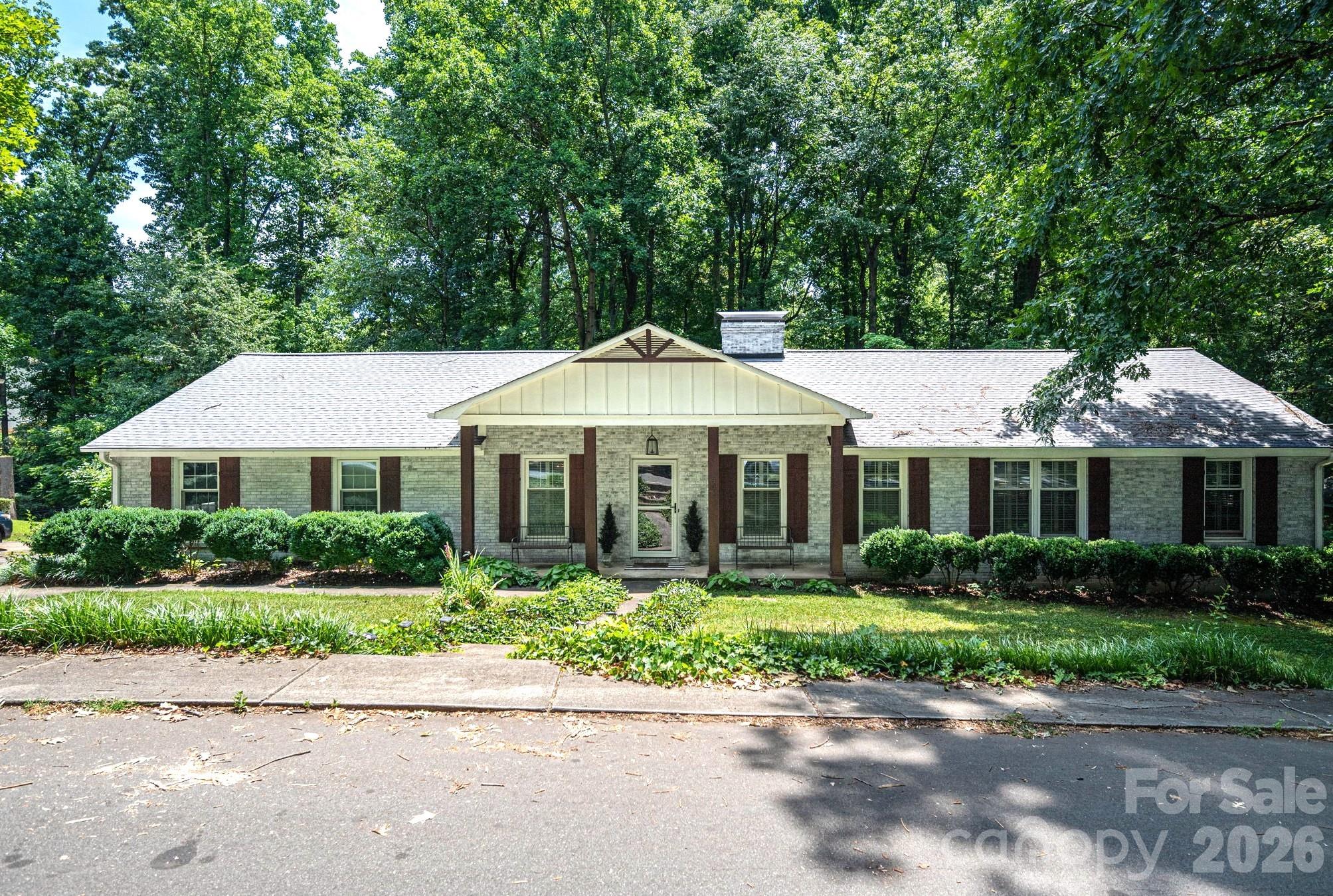 Walk to Downtown Belmont from this gorgeous updated brick ranch with rare privacy for an in town property! Located near the end of a cul de sac, this wonderful community with large private lots is a perfect location to commute, schools and to enjoy all that desirable Belmont has to offer. One level living with over 1700 sq ft with charming original details, modern updated conveniences and an unfinished basement for storage or expansion. Front living room with lovely hardwood floors could be study or home office. Dining room with double doors leading to kitchen. The updated kitchen features gas range, lots of counter & cabinet space, coffee station and eat at bar. The spacious great room has a fireplace and a huge picture window overlooking the private backyard with creek & lots of trees. The glassed sun room (unheated) with panoramic views of the .66 acre wooded backyard is the ideal spot to enjoy your coffee or use as flex space for play room, office or gym. All bedrooms have hardwood floors. The primary has 2 closets and an en suite bath. The expansive, light-filled basement provides exceptional utility as a workshop, hobby space, or massive storage zone, with excellent potential to be finished for instant equity.  Enjoy peace of mind with new roof 2025, new HVAC 2022 and new tank less water heater 2022.  Experience the perfect balance of private, neighborhood living just a short walk from Belmont's vibrant shops and dining!