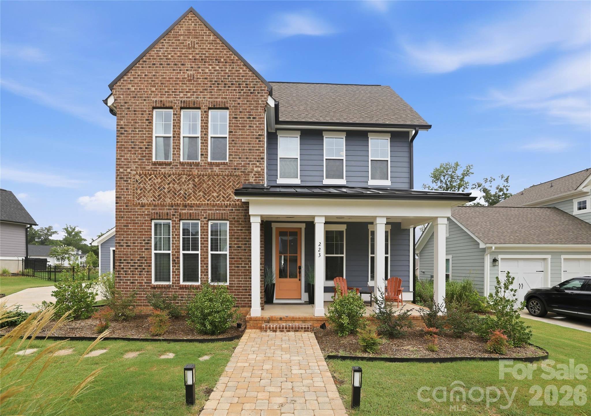 Move right into this beautiful home in the highly sought-after Riverwalk community. One of its most unique features is the rare, private backyard. Unlike many Riverwalk homes, the detached two-car garage is located beside the home, creating a spacious and secluded outdoor area perfect for relaxing, entertaining, or play. The well-appointed kitchen features white cabinetry, quartz countertops, a stylish backsplash, an oversized island, and a gas cooktop. The main-level office offers flexible space and can also be used as a bedroom. The primary suite includes a built-in sauna, creating a spa-like retreat right at home. Additional upgrades include a screened porch, gas line for grilling, and a finished garage with extra outlets and overhead storage. Enjoy Riverwalk's exceptional amenities including walking and biking trails, green spaces, a clubhouse, swimming pool, community fire pits, restaurants, shops, a canoe and kayak launch, BMX track, and Velodrome. Conveniently located with easy access to Charlotte, major roads, dining, and shopping.