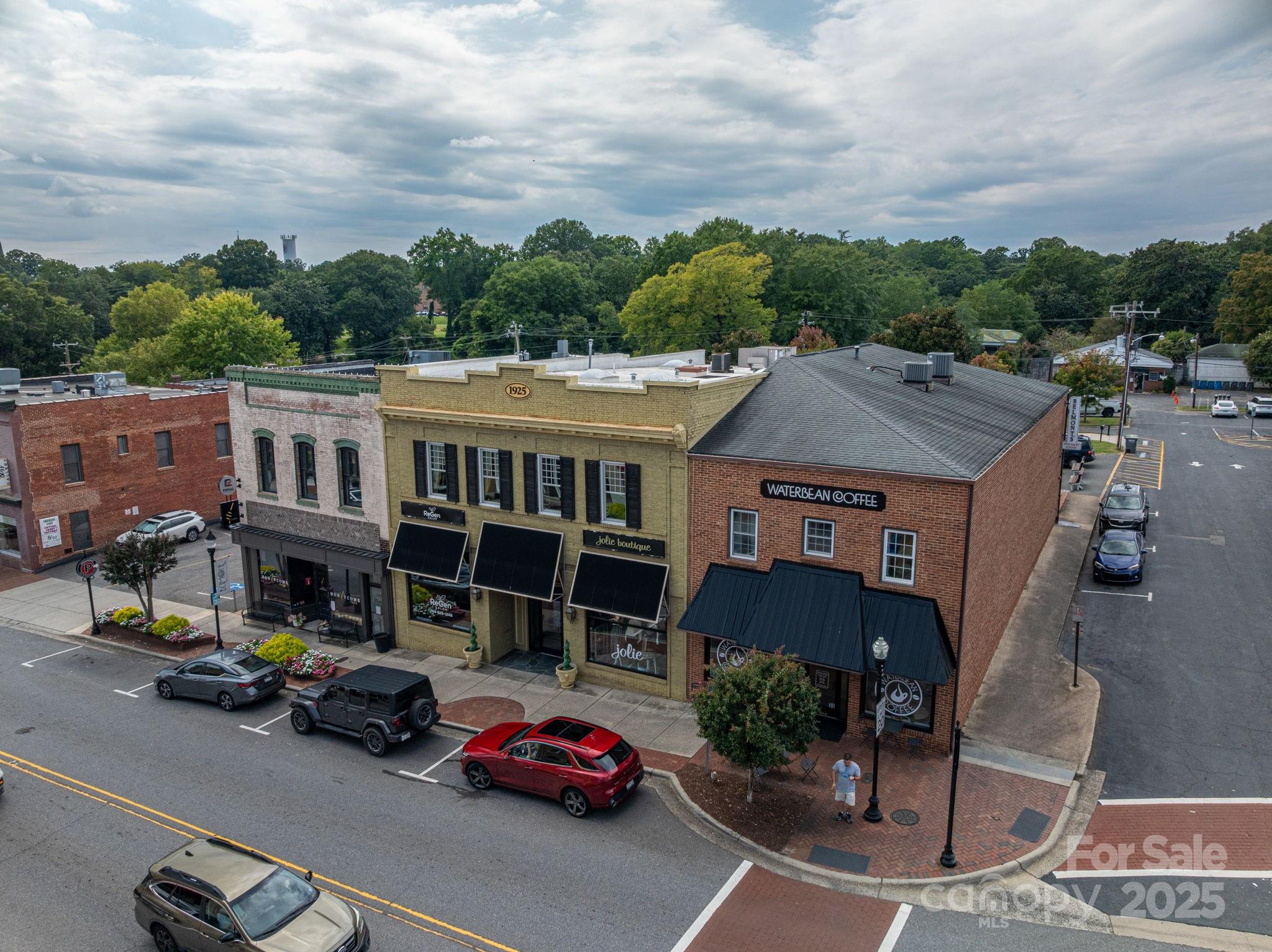 Exceptional Mixed-Use Opportunity in the Heart of Downtown Belmont! This versatile property offers the best of both worlds: retail tenants on the main floor and a rare, downtown residential loft unit on the upper level, ready to generate additional income or serve as an owner's retreat! The upper-level apartment blends modern comfort with historic charm- featuring exposed brick walls, rich hardwood floors, and an open-concept design! Enjoy a private elevator ride to your second-floor sanctuary, where a spacious living room, dining area, and reading nook provide ample space for entertaining or relaxing. The chef-inspired kitchen boasts granite countertops, double ovens, a gas cooktop, a center island, and a cozy fireplace... perfect for gatherings. Enjoy TWO expansive primary bedrooms, each with an en-suite bathroom, adorned with granite vanities, individual linen closets, and private water closets. Unwind on the balcony overlooking a peaceful courtyard, or pamper your fur-baby in the dedicated Dog Spa Room—a rare and thoughtful touch! This property combines investment potential with an elevated lifestyle, all in the midst of Belmont’s vibrant shopping and entertainment scene! Property is cross-listed as COMMERCIAL, MLS #4315742.