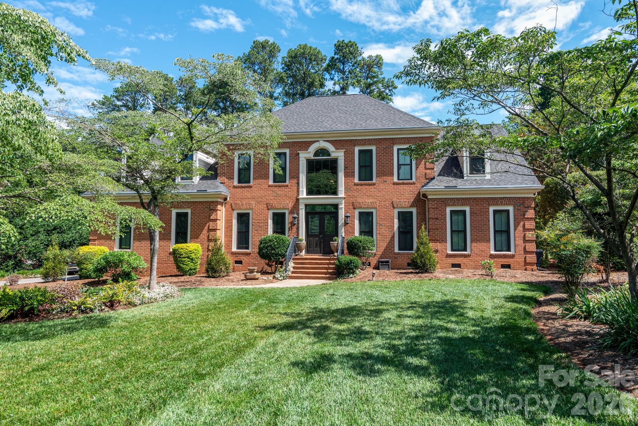 Welcome to the style and comfort of The Peninsula in this well-maintained home overlooking the 14th fairway and green of the prestigious Peninsula Club golf course. This lovely home is located on a quiet cul-de-sac just one block from Jetton Park, with its walking trails and expansive views of Lake Norman. It offers the prestige of The Peninsula plus the convenience of close proximity to dining, shopping, banking and much more. The home is all brick and features dual staircases.  The main level features a great room w/fireplace & gas logs along with lots of built-in book/display cases w/storage below. The Primary bedroom with tile bath is on the main floor.  Primary bath has a walk-in closet, extra-large vanity and separate water closet. The great room opens into the well-appointed kitchen w/SS appliances including refrigerator, double oven, and microwave plus trash compactor, as well as a center island w/gas cooktop. All the countertops are granite w/travertine backsplash. This is complimented by a large breakfast room.  Upstairs are 3 bedrooms, plus a spacious bonus room as well as a 5th bedroom/hobby room and two full bathrooms. A screened porch and open deck look out over the golf course. The double garage offers porcelain tile floors and adjoins a separate storage room. Upgrades include all new APEX, triple-glazed windows plus new front and rear steel doors within the past year.  New gutter guards in 2026, plus the roof is only 2.5 years old.  The home offers mature landscaping plus a beautifully maintained lawn with in-ground irrigation. This spacious home offers the best features of life in The Peninsula.