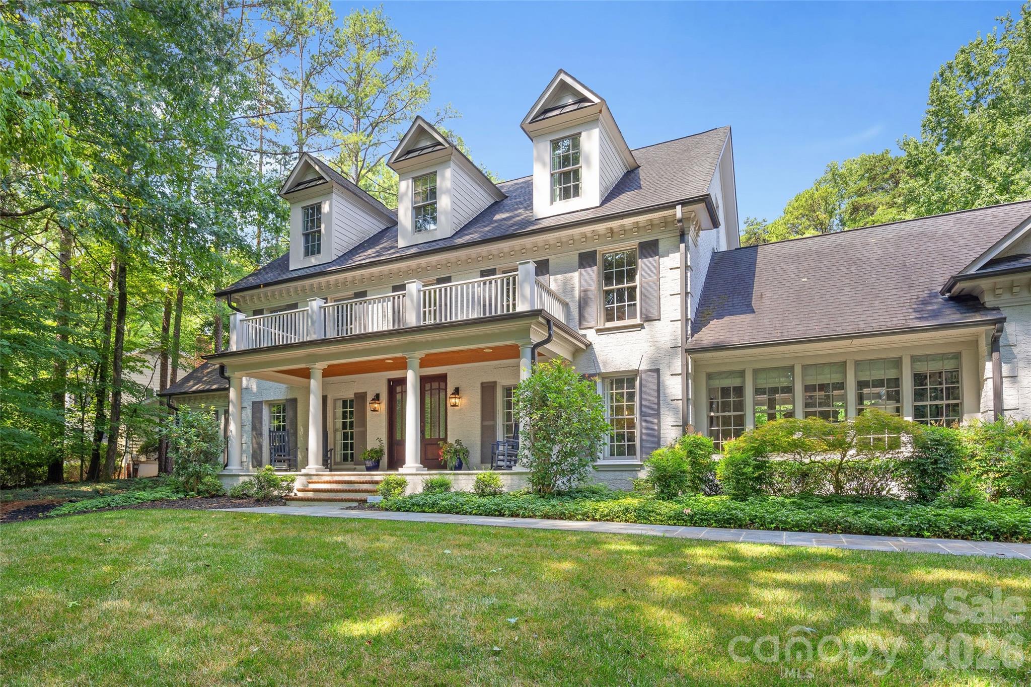 Nestled in the highly desirable Providence Plantation neighborhood, this stunning estate has been extensively renovated from top to bottom, blending timeless architecture with sophisticated modern design. A major 2016/2017 renovation transformed the home with a new chef's kitchen, vaulted family room, expanded bonus/media room, luxurious primary suite and bath, first-floor mudroom, laundry room and powder room, second-floor laundry, and new hardwood floors on the upper levels. Major updates also include the roof, gutters, HVAC systems, garage door and opener, relined pool, pool house, and a new driveway completed in 2026. The open, light-filled floorplan is designed for effortless living and entertaining. The beautifully renovated kitchen features painted white cabinetry, granite countertops, a large center island, commercial-grade range, and breakfast area, all opening to two spacious family rooms. One family room showcases a dramatic vaulted ceiling and flows seamlessly to the covered outdoor living area with a stone fireplace. Formal living and dining rooms, a private office, hardwood floors, and extensive moldings complete the main level. Upstairs, the spacious primary suite offers a beautifully renovated spa bath with a soaking tub, oversized shower, and dual vanities. Four additional bedrooms, a second laundry room, and a large bonus room provide exceptional flexibility. Outside, enjoy a welcoming front porch, covered patio with fireplace, sparkling pool, renovated pool house with a full bath, and an expansive backyard with room for a pickleball court, sport court, workshop, or play lawn. Completely move-in ready, this exceptional home offers luxury living in one of South Charlotte's most sought-after neighborhoods.