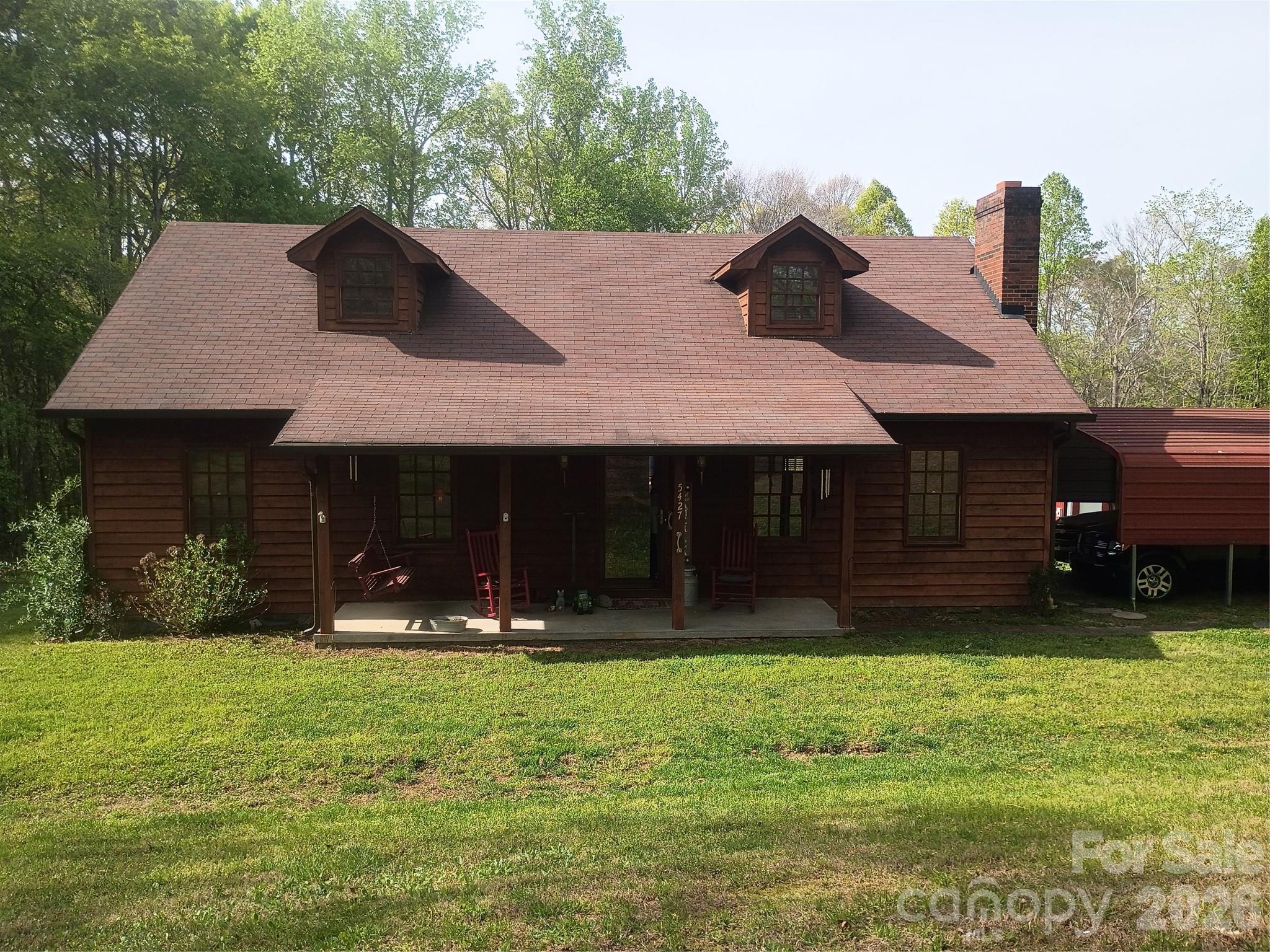 Experience country living at its finest! This welcoming home offers a cozy living room with a wood fireplace insert, a spacious kitchen, and an open dining area exit to nice deck overlooking backyard. The main level includes 2 bedrooms and 2 full baths, while the upstairs flex room—currently used as attic space—could easily be finished into a bedroom, office, or hobby room.

Set on 2.67 peaceful acres, the property features mature hardwoods, a garden spot, and excellent outbuildings: a 26x32 workshop with concrete floor, garage door, floor hoist, and air compressor, plus a 20x20 carport and a storage building with tractor shed. A circle drive adds convenience and charm.

You truly must see this property to appreciate all it offers. Please pardon the boxes as the seller prepares for her move.