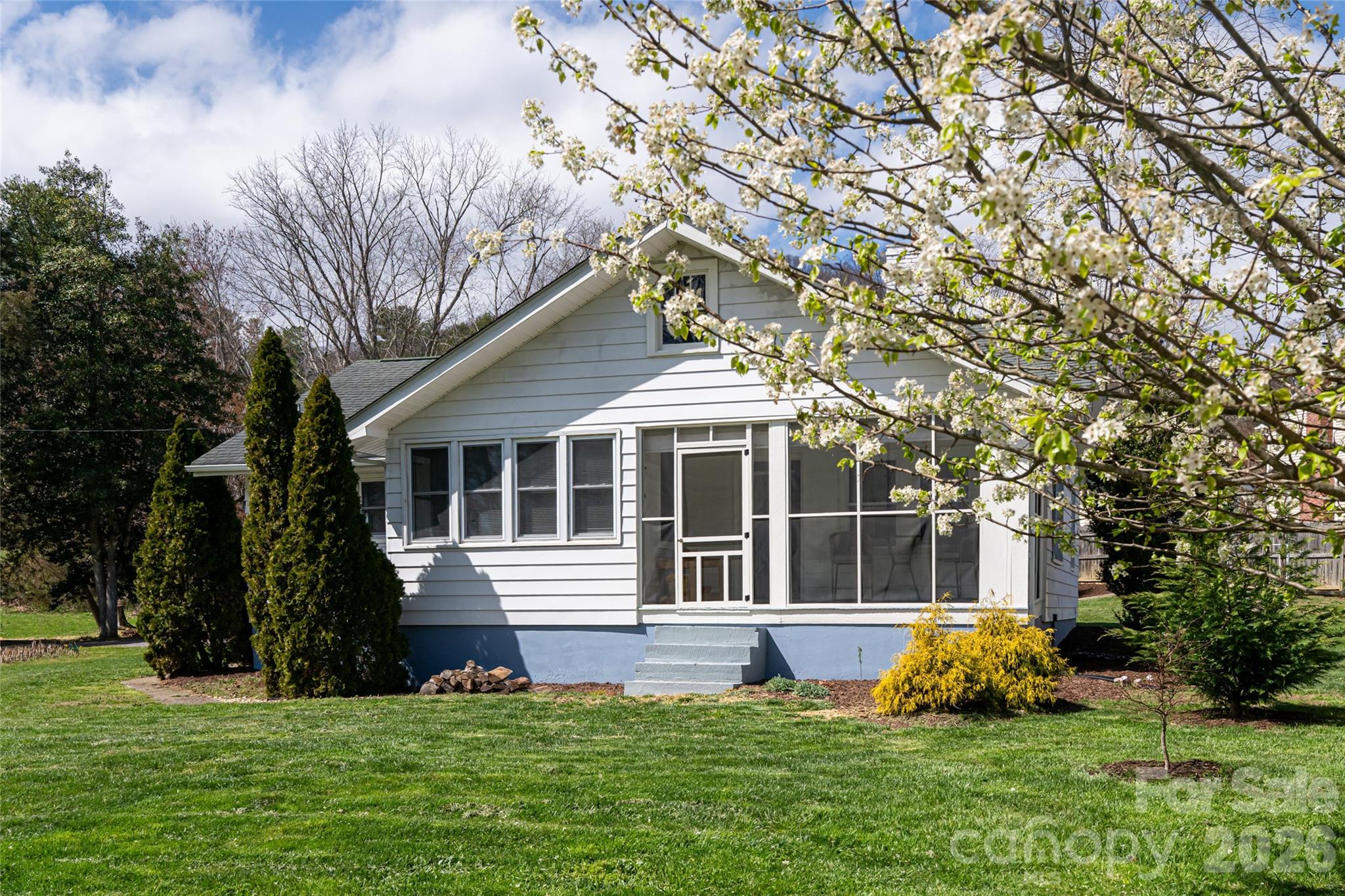 This updated home is gated and has potential to subdivide. Truly turnkey with major improvements including a new roof, windows, plumbing, electrical. In the Riceville Valley, where the mountains cradle the land and the noise of the world fades behind you, this bright classic bungalow sits above a gentle, babbling stream that begins its journey near the Blue Ridge Parkway. Helene caused no damage to this home. Perfectly positioned between downtown Asheville and Black Mountain, and less than three miles from the Parkway itself, you’re tucked into the landscape yet minutes from everything. It’s the rare kind of location that feels hidden but never isolated. And then there’s the freedom of county taxes and zoning. No restrictions from an HOA. Chickens? Yes. Short-term rentals? Allowed. Homesteading dream? Fully possible. With the largest lot in the immediate cluster, this property offers room to breathe and room to grow. City water and sewer are already in place, with the potential to add an ADU or even explore subdivision options (buyer to verify). Classic design layered with modern touches. Curl up by the new free-standing wood stove with your favorite book. Outside, raised garden beds soak up the valley sun. Evenings unfold under a canopy of stars as fireflies spark to life and conversations stretch long past dusk. The fire pit glows. The air cools. Adventure lives at your doorstep. Ride straight up to the Blue Ridge Parkway. Explore nearby trails at Warren Wilson College. Wander into surrounding national forest lands and protected nature preserves. This is a landscape people travel to experience and you get to call it home. Practical improvements add peace of mind: a redone culvert with reinforced rip rap, added electrical amp service in the detached carport for workshop potential or future expansion, and access to a natural spring for fresh mountain drinking water. This home isn’t just a place on a map. It’s where you land.