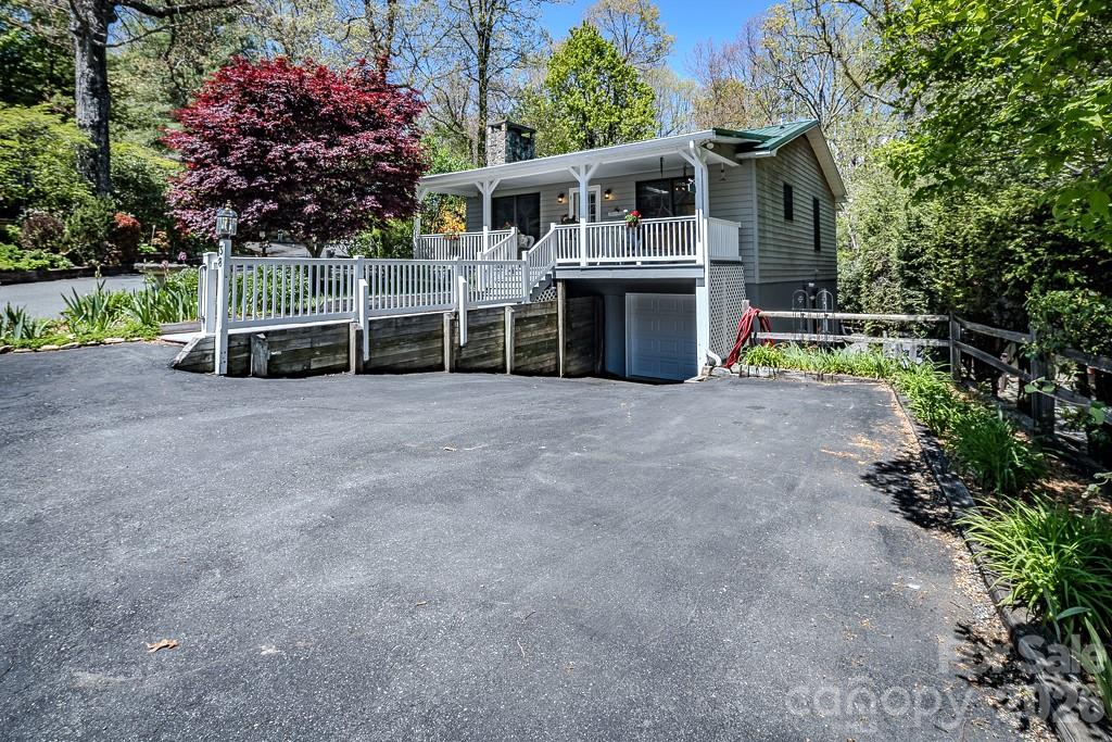 Fully furnished and move-in ready, this light and bright and hard to find 4BR/3BA cedar mountain cottage captures the perfect blend of mountain charm and modern comfort. Inside, you’ll love the cozy living room with its inviting stone fireplace — the heart of the home and ready for relaxing mountain evenings. The home comes tastefully furnished, making it truly turnkey. Step outside to enjoy outdoor living on the covered front porch with swing, overlooking beautifully landscaped grounds. The fenced level backyard is highly desirable for pet lovers, gardening or outdoor enjoyment. Recent upgrades include a brand-new metal roof (2025), fresh interior paint, updated lighting, new ceiling fans throughout, high-grade vinyl flooring, and beautifully updated bathrooms. Energy-efficient Andersen windows complete the thoughtful improvements. You'll also enjoy the 1 car garage with extra space for hobbies, projects, or storage. A newer washer and dryer are also included — just bring your suitcase and start living the mountain dream! Linville Land Harbor amenities include a golf course, lake access for fishing and kayaking, heated seasonal swimming pool, tennis and pickleball courts, fitness center, walking trails, dog park, playground, clubhouse, year-round activities, and 24/7 security. This one you won't want to miss!