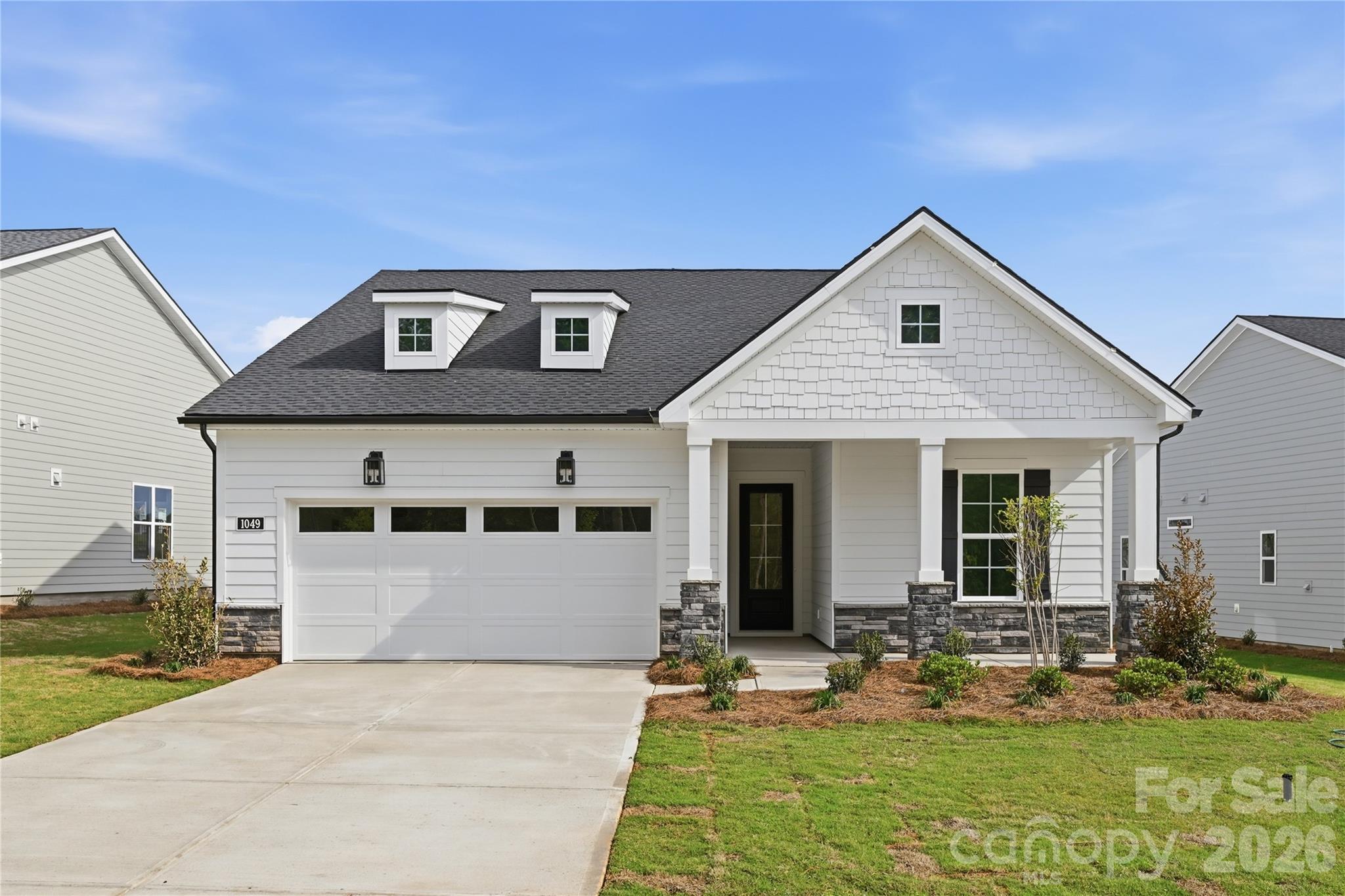 Move-In Ready with Designer-Appointed Finishes and Exceptional Indoor-Outdoor Living on homesite #218! This beautifully crafted home offers the perfect combination of luxury, flexibility, and comfort. Designed for both everyday living and entertaining, the spacious kitchen features abundant cabinetry, a convenient butler's pantry, and flows seamlessly into the casual dining area, creating an inviting space for gathering with family and friends.

Just beyond, the covered rear porch becomes a true extension of the home, showcasing a stunning stone gas fireplace—perfect for relaxing evenings, outdoor entertaining, and year-round enjoyment. The expansive great room provides ample space for hosting larger gatherings while maintaining a warm and welcoming atmosphere.

A versatile first-floor flex room offers endless possibilities, whether you need a home office, hobby room, fitness space, or additional living area. The private primary suite serves as a luxurious retreat, complete with a spacious bedroom and spa-inspired bath designed for comfort and relaxation.

Upstairs, a generous loft/flex space, private guest bedroom with walk-in closet, and full bath create the ideal setup for visiting family and friends, offering both privacy and convenience.

Located in The Pines at Sugar Creek, a premier 55+ community designed for active, low-maintenance living, residents can immediately enjoy the newly opened resort-style amenity center featuring a clubhouse, fitness center, pool, outdoor spa, pickleball courts, tennis courts, bocce courts, and a vibrant social lifestyle. This is a rare opportunity to enjoy a beautifully finished, move-in ready home in one of the area's most desirable active-adult communities