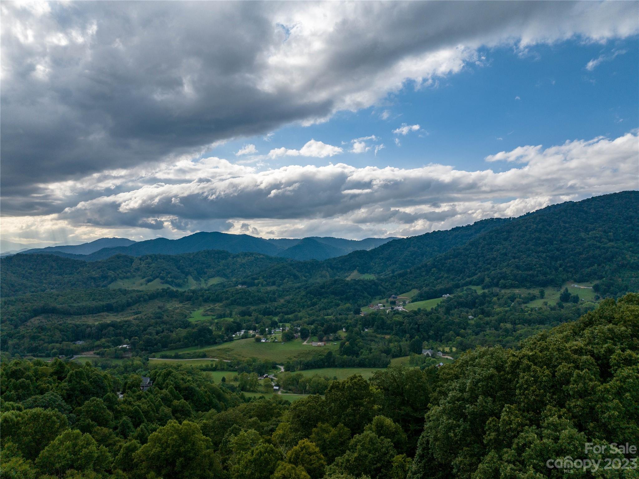 Over 2 acres of privacy and some of the most beautiful views in all of Haywood County. The views from this lot will be sure to wow you! This lot in Hunters Ridge subdivision has super easy access. Paved to the top of the subdivision with a little bit of gravel road to get to the lot with a roughly graded driveway. Perfect building site at the peak of the lot where it levels out nicely. Light building restrictions for this community. Come see this one today as it's sure to please!