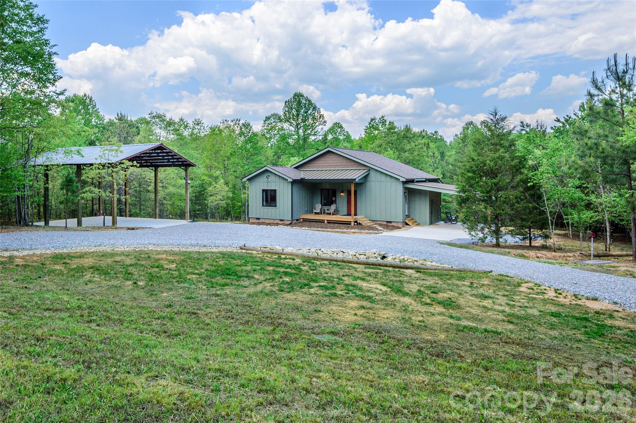 Welcome Home to 107 N Dakota Drive! Located in a beautiful gated community approximately four miles north of Downtown. Subdivision includes common recreational area, complete with a picnic area and playground. Enjoy the peaceful, natural and walk-able setting. Home was completed end of 2025 virtually brand new and is completely Move in Ready! Features many upgrades including; 38” high countertops/vanities, Custom Cabinetry work, Solid Shaker Doors, Hickory Flooring, Marvin Casement Windows throughout, all Led lighting, additional electrical outlets throughout, standing seam metal roof & enlarged 30 Year Architectural shingles & LP SmartSide siding. Open Concept Kitchen features Quartz countertops, Stainless Steel appliances & Pendent Lighting. Ample Laundry Room, features Quartz Countertops Pantry & Built in Bench, leads to Attached Carport 14 x 16- stunning tongue & groove ceiling, adjacent electrified storage room, 12.3 x 4.7. Baths with custom subway tile, Quartz countertops & plenty of storage. Family room features Gas Fireplace leads to stunning Covered Rear deck, 22.7 x 9.3, vaulted tongue & groove ceiling and stylish wall sconces, hot tub ready! 24’W x 30’L x 17’H additional Carport with substantial 8 x 8 supports perfect for additional Vehicle or RV storage. There is plenty of storage and easy access to the lighted crawl space. Located 30 minutes to Chimney Rock, 15 Minutes to Forest City and 20 Minutes to IEC. Make your appointment today!