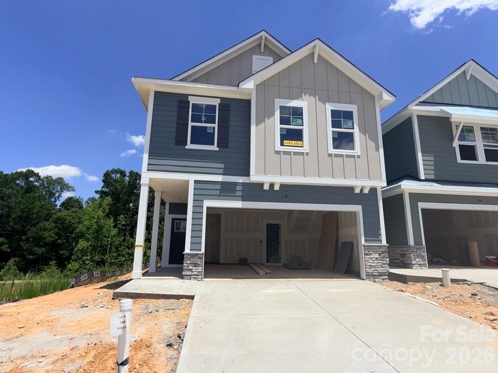 END Townhome on one of the best homesites in the community-Discover the ease of luxury low-maintenance living in this brand-new Bushwick IV townhome, conveniently located just minutes from Ballantyne, Waverly, and the charming shops and restaurants of historic downtown Waxhaw. Filled with natural light, the open-concept living area is highlighted by three large picture windows overlooking a private wooded backyard. The designer kitchen features 42” Frost colored soft-close cabinetry, sleek quartz countertops, a spacious wrapped island open to the family room, Frigidaire stainless steel appliances, an exterior-vented range hood, and a pantry with solid shelving. The main level showcases durable LVP flooring throughout, along with composite stair treads leading to the second floor. Upstairs there is a loft area with LVP flooring, unwind in the luxurious Owner’s Retreat featuring a tray ceiling, oversized walk-in closet, and three large windows that create a bright, airy feel. The spa-inspired primary bath offers tiled flooring, a large tiled walk-in shower with bench seating, oversized dual vanity with quartz countertops and soft-close cabinetry, a linen closet, and a private water closet. The second floor also includes two spacious secondary bedrooms, a full hall bath, and a thoughtfully designed laundry room with tiled flooring and a convenient folding table. Enjoy peaceful mornings or relaxing evenings on the covered porch overlooking the wooded nature preserve. A side-by-side two-car garage and full driveway provide ample parking for both homeowners and guests. With low taxes, low-maintenance living, and the feel of a single-family home, this townhome offers the perfect blend of comfort, convenience, and style. This home is located on one of our best home sites at the end of the street next to the nature preserve surrounding by trees! Ask about special low-interest rate opportunities