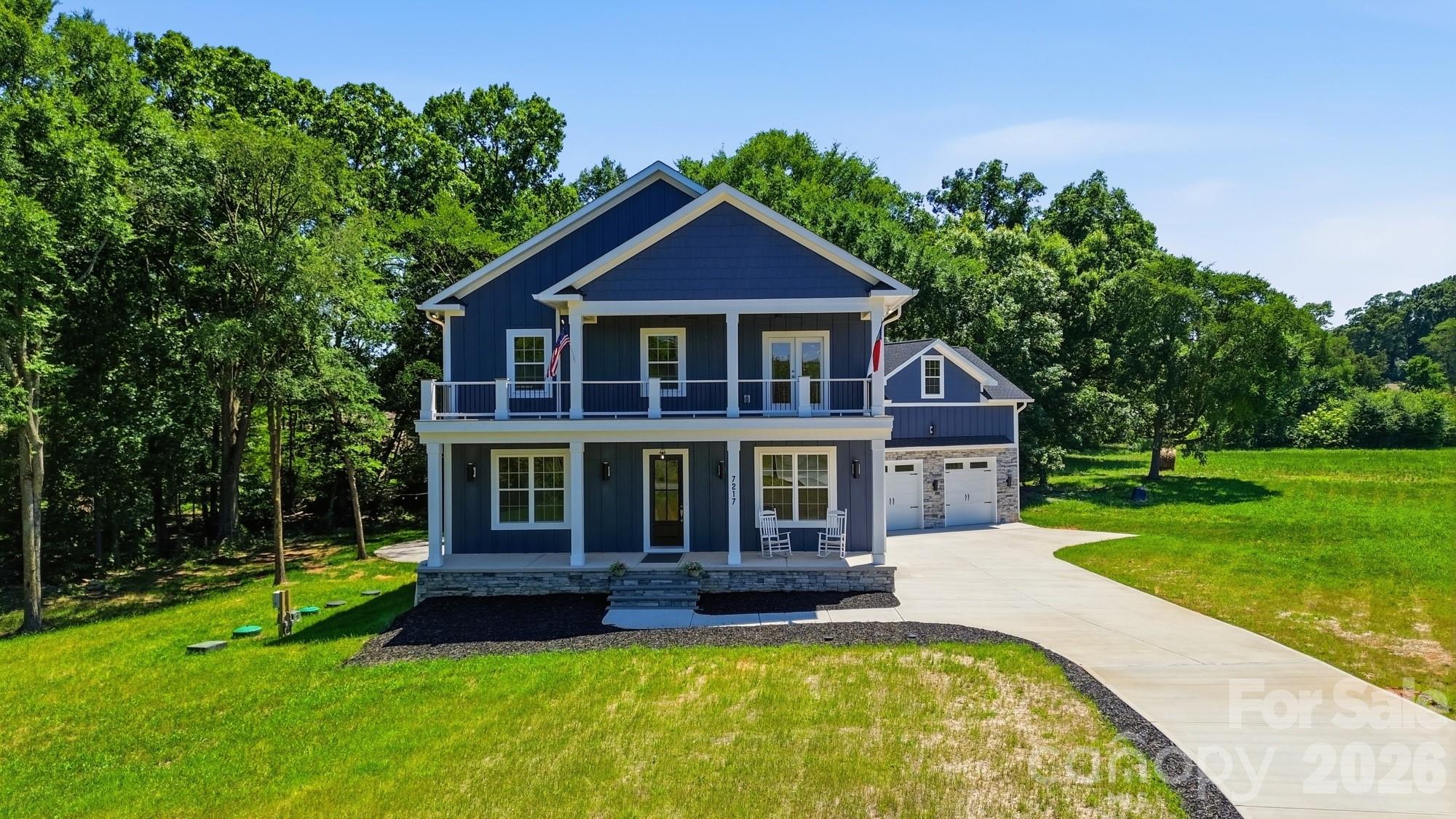 This custom built new construction located on 2+ acres is waiting for you to be the first to call it home! Double front porches greet you as you step inside to find a bedroom or office with full bath and a generous size great room that opens to the dining area with custom lighting and built-in beverage bar. The great room opens to the well appointed kitchen featuring ceiling-height cabinetry with illuminated upper cabinets, under cabinet lighting, quartz counters with room for bar stool seating, a breakfast area, and a scullery with sink and convenient “delivery door” access from the garage. Throughout the home, you’ll find custom details such as crown molding in the great room, hardwood flooring, designer tile in every bathroom, and custom closet systems. On the upper level you will find a versatile loft or library with custom built-ins and a Murphy door that leads to an  impressive 750+ sq. ft. bonus room. The primary suite is located just off of the loft area and features its own private beverage station—perfect for a peaceful morning coffee or relaxing evening glass of wine on the private porch and a luxurious bath featuring a walk-in shower with dual shower heads and a custom closet. Two generous size secondary bedrooms with a jack-n-jill bath and a conveniently located laundry room completes the upper level. Enjoying the outdoors is easy from the screened porch or the 1000 square foot outdoor living space that overlooks the beautiful wooded views and creek that runs thought the side of the property. An oversized garage provides ample space for a workshop or  equipment storage. Located in a quiet, country setting you are minutes to Monroe or Mint Hill, where you can enjoy walking to outdoor dining spots and farmers markets. Builder warranty provided (2-10 Home warranty).