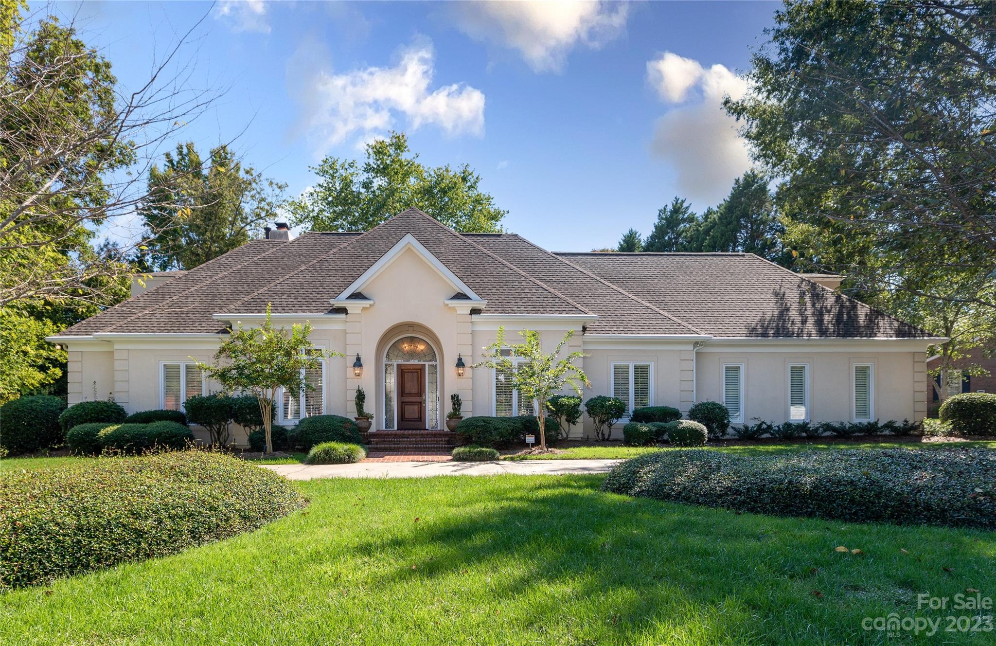 A rare opportunity to live in one of Rock Hill's most desirable neighborhoods. The location seems tucked away but is only 3 miles to I-77. Built by The Warren Norman Company, this unique and beautiful home is filled with natural light. All four bedrooms have recently updated ensuites, the primary bath has a large glass/tile shower and freestanding tub. The spacious primary bedroom has two closets with wooden shelves and drawers, gas log fireplace and access to the large back patio. Entertain in the large open living space that connects the dining room, great room with fireplace, kitchen, breakfast area with beverage bar and sitting room. Pella Windows and Plantation shutters throughout. The Kitchen provides granite countertops, high end appliances with double oven and warming drawer, gas stovetop and a refrigerator. Brand new concrete circular driveway. Upstairs has a large cedar hall closet. Hardwoods throughout and downstairs hardwoods replaced in 2023.