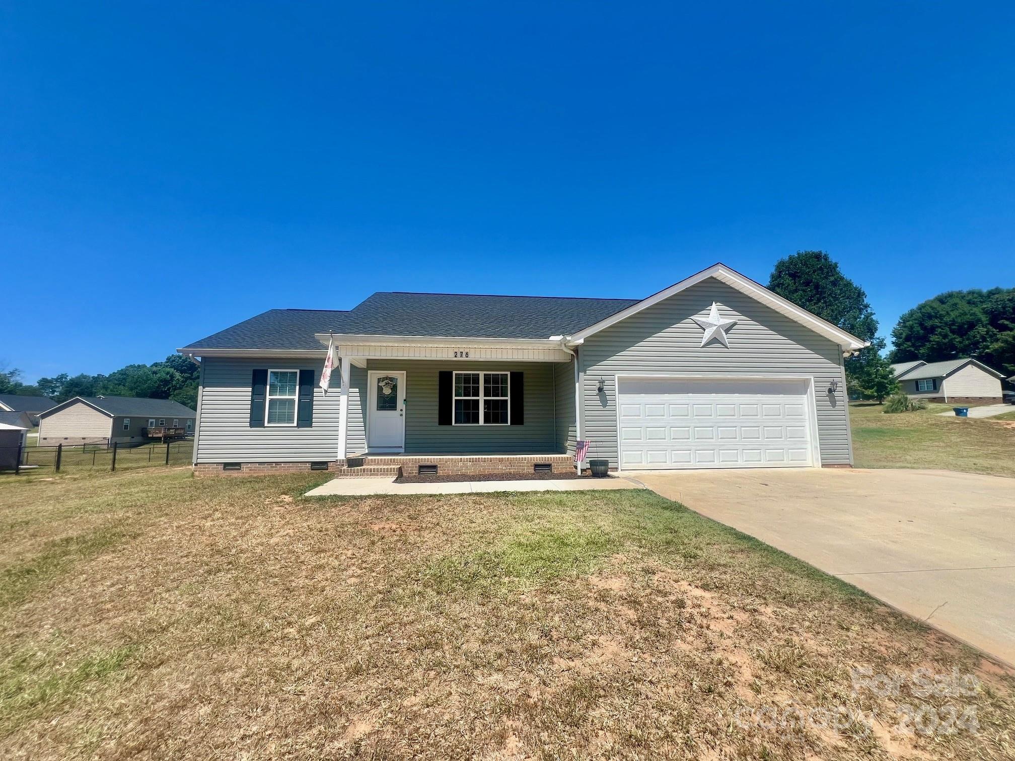 Very well kept 3br/2ba property close to schools, shopping, dining and golf. This open floor plan along with the vaulted ceiling and recessed lighting allow for a roomy feel.  Kitchen features all stainless steel appliances accented with white cabinetry.  Walk out the dining area doors to a covered patio out back and enjoy entertaining family and friends.  A partially fenced in yard is welcoming to your four legged friends. Just a short drive to Lenoir and Wilkesboro.