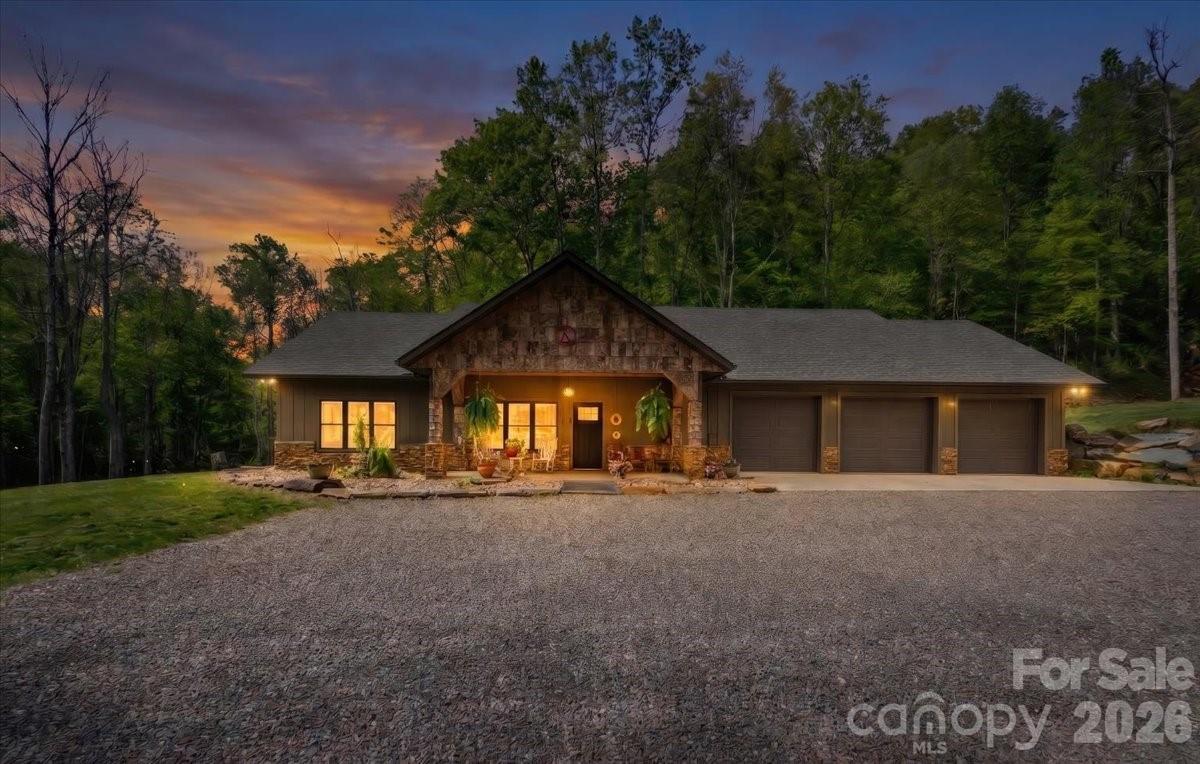 Forest Springs Lodge brings Montana to Western North Carolina. Living right on Big Crabtree Creek (known for its native trout) and 17 acres that partially borders the National Forest offers a rare level of solitude.  The kitchen is a chef’s dream consisting of a ZLINE gas range, microwave and a Sub-Zero refrigerator, along with granite counter tops, a farm sink, spacious kitchen bar and a large walk-in pantry.  Large back patio off the kitchen is great for relaxation while listening to the bold creek flow by. The spacious open concept of dining room, kitchen and living room make it great for family gatherings and entertaining, while warming up to the cozy fireplace on cold winter days.  The split floor plan with 3 bedroom/ 3 bath is great for privacy, and having ensuite baths for every bedroom is a premium touch that guests or family members will love. In the primary suite is a walk-in tile shower and soaking tub creating a true spa-like retreat, while the walk-in closets and in-suite laundry add serious practical value. Also, off the primary bedroom is an office for those who wish to work from home.  A 3-car attached garage plus a dedicated 42 x 26 ft. RV garage and workshop is a dream for hobbyists, woodworkers, or anyone needing to store outdoor gear for exploring the nearby creek and forest.  Close to the Blue Ridge Parkway for hiking enthusiasts, Spruce Pine is 30 mins and Burnsville 30 min drive.