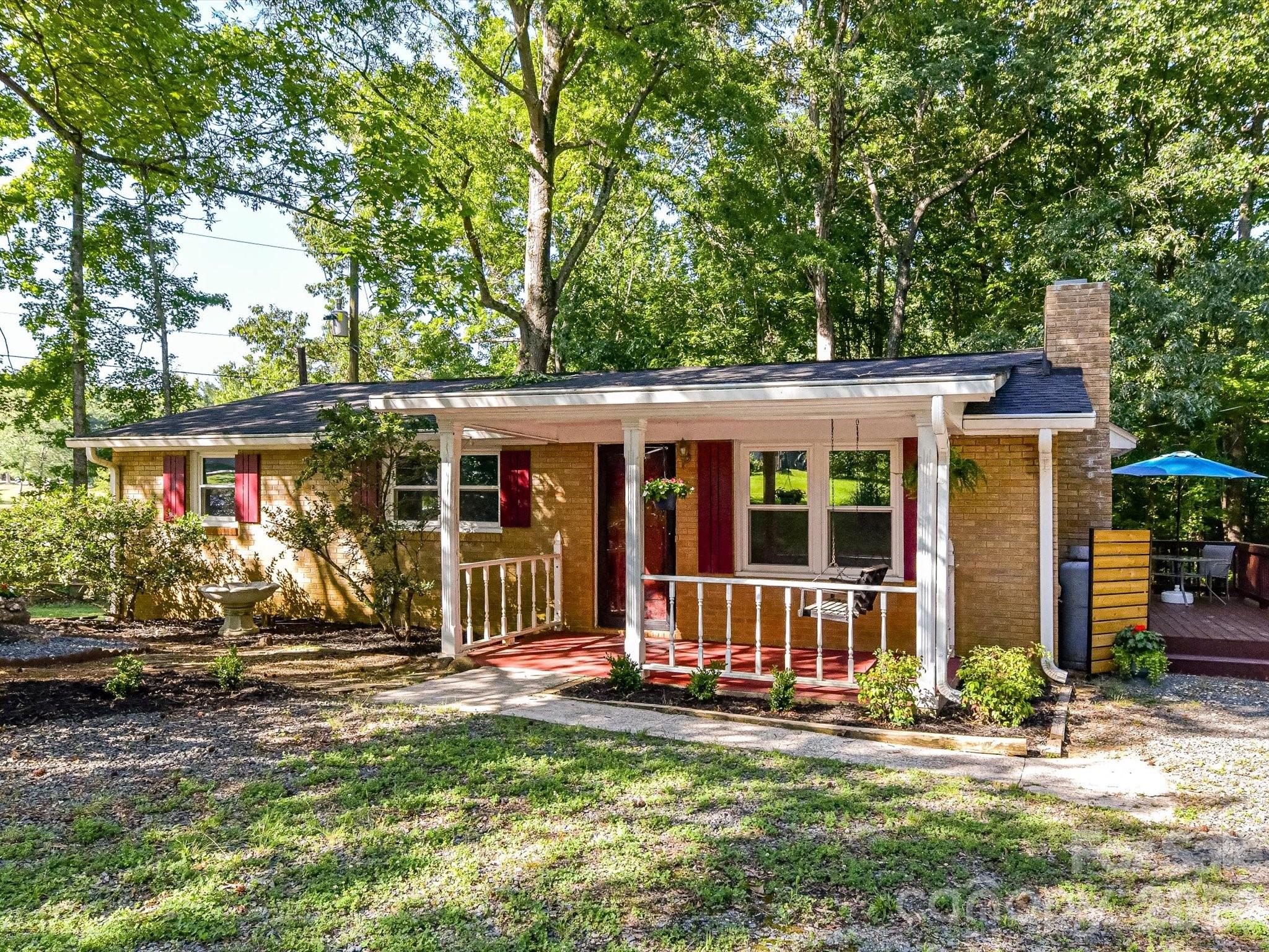 JUST BLOCKS FROM DOWNTOWN WAXHAW RESTAURANTS, SHOPPING & WAXHAW ELEMENTARY**Refreshed Brick Ranch with 864 Sq Ft Detached Workshop: A sensational opportunity in a prime, highly sought-after Waxhaw location. This adorable brick ranch home with its covered porch sits on a quiet street on a rare, over half-acre homesite with peaceful pond views on the neighboring property. Located less than a mile from the heart of downtown Waxhaw’s dining, shopping, and Waxhaw Elementary School, this property perfectly balances small-town convenience with everyday privacy.  Fresh paint, carpet, and LVP make this home move-in ready! Major systems have been updated since 2022, offering absolute peace of mind: a newer roof on both structures, a new 2025 HVAC system, modern vinyl replacement windows, professional foundation reinforcement, freshly painted, new lvp flooring and carpet. The cozy living room features a gas log-operated fireplace, formerly wood burning has been sealed. Inside, the light-filled 1,025 sq ft layout features 3 bedrooms, 1.5 baths, fresh interior paint, and a refreshed kitchen equipped with a brand-new range oven and updated plumbing fixtures. Modern light fixtures and ceiling fans run throughout the home. Relax on the charming, tree-shaded front porch or entertain on the spacious deck overlooking your expansive backyard.  The ultimate crown jewel of this property is the detached, over 850 square foot frame garage and workshop, which includes 220-volt electrical service, heat, and a remaining air compressor. This expansive secondary structure is an absolute dream for tradespeople, vehicle storage, a private studio, or a potential future conversion into an ancillary living space/ADU up to approximately 500 sq ft of the structure (buyer to verify local zoning ordinances and square footage limitations with the Town of Waxhaw). Come visit today!
