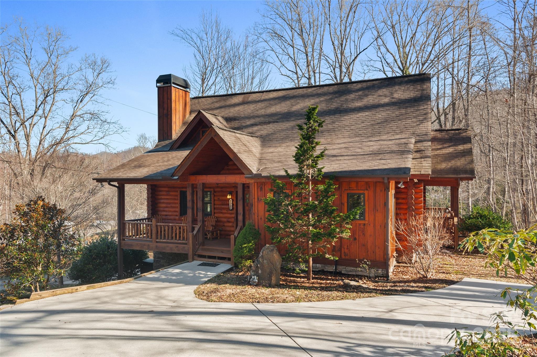 This stunning log home offers the perfect blend of location, year-round accessibility, and a serene park-like setting. Enjoy the outdoors from the front, side, and back porches. Inside, the bright great room features pine flooring, a mix of drywall and log walls, and a 20-ft vaulted tongue-and-groove ceiling with a floor-to-ceiling stone wood-burning fireplace. The spacious kitchen boasts granite counters, a breakfast bar for four, custom cabinetry, a stylish backsplash, and a walk-in pantry.The main floor includes a butler’s pantry/laundry, a primary suite with a walk-in closet, and a luxurious bath with double vanities, a jetted tub, and shower. Upstairs, find a loft, two guest bedrooms, and a bath with double vanities. The lower level offers a rec room/den and garage and storage. This home combines rustic charm with modern comforts for the ultimate mountain retreat. Home is being sold with remaining personal items and furnishings.