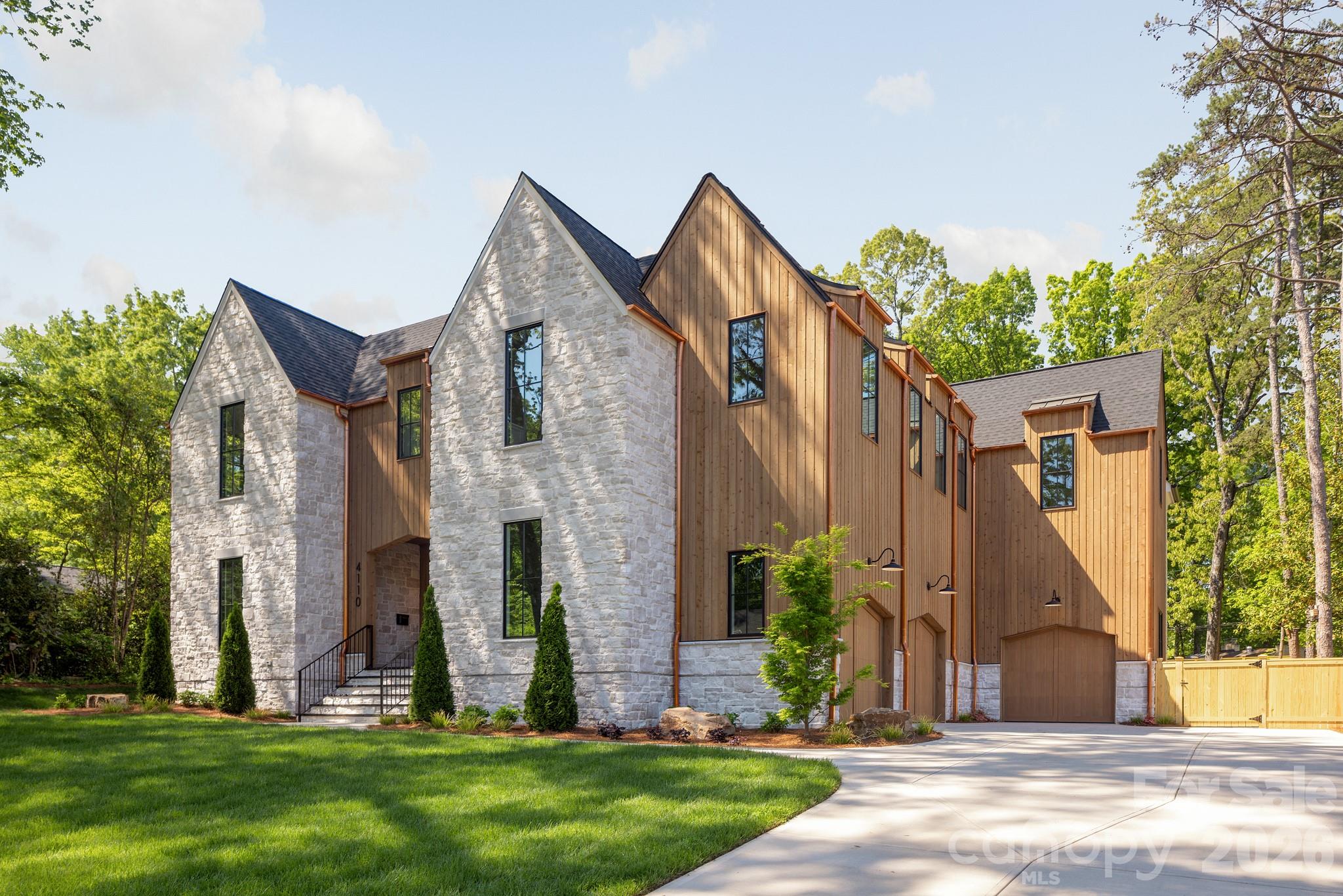 Perfectly positioned in the heart of Cotswold, 4110 Melchor Avenue is a masterfully crafted Scandinavian Modern new construction by Pike Properties — a home that redefines luxury living in one of Charlotte's most coveted neighborhoods. With 5,939 square feet of thoughtfully designed space, every detail has been considered to deliver a living experience that is both elevated and effortlessly livable.
The architectural language is clean, intentional, and unmistakably Scandinavian — defined by natural materials, warm minimalism, and a seamless dialogue between interior and exterior. Soaring ceilings, walls of glass, and an abundance of natural light create an atmosphere that feels expansive yet intimately comfortable. Custom cabinetry flows throughout the entire home, a thread of craftsmanship that ties every room together with quiet sophistication.

At the heart of the main level is a showpiece kitchen that is as functional as it is stunning — and behind it, a full scullery kitchen running the entire length of the main kitchen, discreetly housing a beverage refrigerator, refrigerator pull-out drawers, 2nd dishwasher, and everything needed to keep the main stage pristine while entertaining. Whether hosting an intimate dinner or a grand celebration, this kitchen pairing is a chef's and entertainer's dream realized.

Step outside and discover an expansive back porch that lives like a true extension of the home. Three remote-operated phantom screens allow you to open or enclose the space at will, while a fully appointed summer kitchen, dedicated dining area, and outdoor living room with fireplace create an al fresco environment worthy of the interior it mirrors. Rain or shine, the outdoor living here is unmatched.
Upstairs, each bedroom enjoys the luxury of a large private closet and its own en-suite bathroom — a thoughtful design that offers every member of the household their own retreat. A dedicated powder bath serves the bonus room, ensuring convenience without compromise. Tucked into its own private wing, the primary suite is in a category of its own — anchored by soaring 12-foot vaulted ceilings, a massive walk-in closet, and a spa-inspired bathroom that transforms the daily routine into a restorative experience.

Even the details you didn't know you needed are here — including a dedicated dog wash station that speaks to the home's rare combination of luxury and genuine livability. The three-car garage completes a package designed for the way people actually live.

Located minutes from premier dining, boutique shopping, top-rated schools, and the energy of SouthPark, 4110 Melchor Avenue offers the quiet sophistication of one of Charlotte's most desirable streets — and a standard of living that is simply without equal.