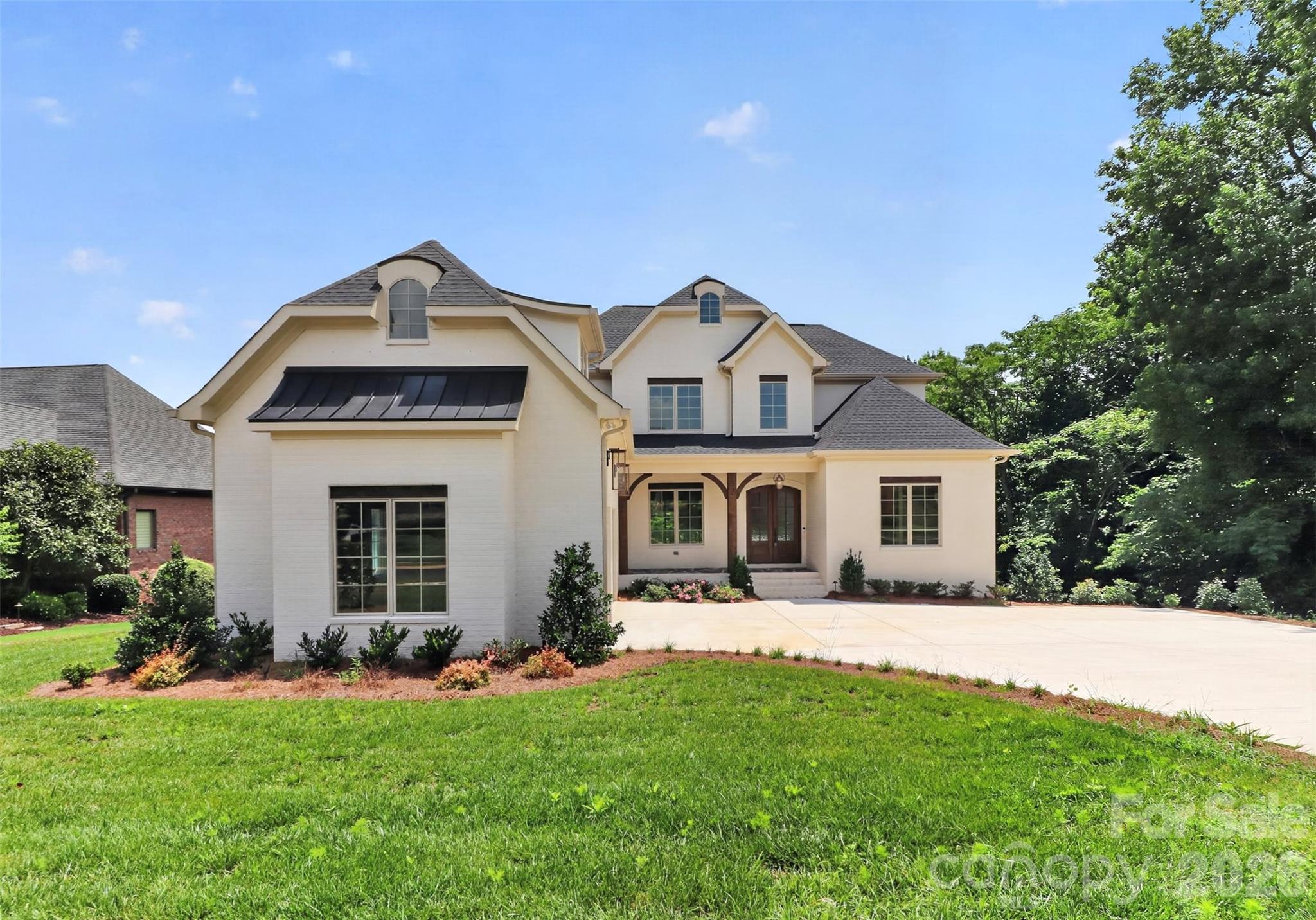 New construction in the prestigious gated Joslin Pointe community on Lake Wylie! This stunning 6-bedroom, 6-bath home offers a spacious open floor plan perfect for entertaining and everyday living. Enjoy lakefront living with your own covered dock and boat lift already in place—just steps from your backyard or enjoy the views from your covered porches. The gourmet kitchen features a large island, premium finishes, and high-end appliances, ideal for hosting and culinary creations. The finished basement offers another living space with  2nd owners suite, family room with wet a bar, island with beverage fridge, icemaker and a versatile space with an optional room ideal for a golf simulator, home theater or workout area. Thoughtfully designed with luxury and comfort in mind, this property provides breathtaking lake views, modern elegance, and private access to one of the area's most sought-after waterfront communities. Live the lake life in style! 
Pictures will be updated after landscaping is completed.