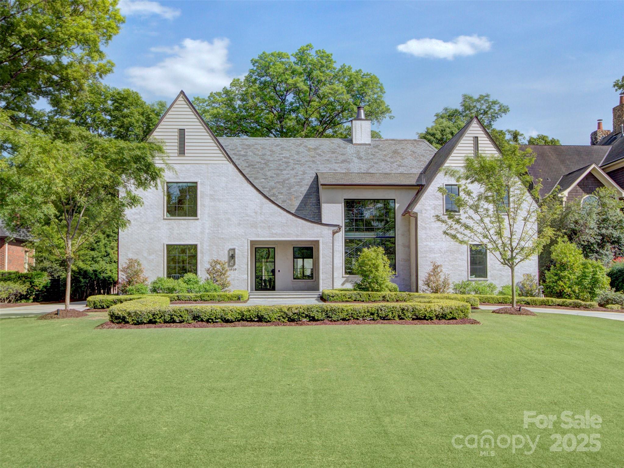 Stunning custom-built Contemporary Tudor by WK Phipps. This full brick home w/ a timeless slurry finish features a natural slate roof, copper flashing, and a luxurious saltwater pool w/ tanning ledge & spa. The 4-car tandem garage w/ 2nd living quarters above, custom steel and white oak staircase, and expansive open floor plan set the tone for refined living. A large automated slider opens to a private pool deck and yard enclosed by brick walls, lush trees, and a motorized gate. The cabana includes a 36” Lynx grill, Big Ass fan, infrared heaters, wood-burning fireplace w/ gas starter, and dual motorized screens. Chef’s kitchen showcases Wolf 48” dual fuel range, plastered hood, Sub-Zero 36” refrigerator & freezer, 24” tall wine fridge, & oversized quartzite island. Primary suite on main level offers a spa-like bath, custom closet, and stacked washer/dryer. Control4 lighting, automated shades, and designer finishes throughout. A true masterpiece with every detail thoughtfully designed!