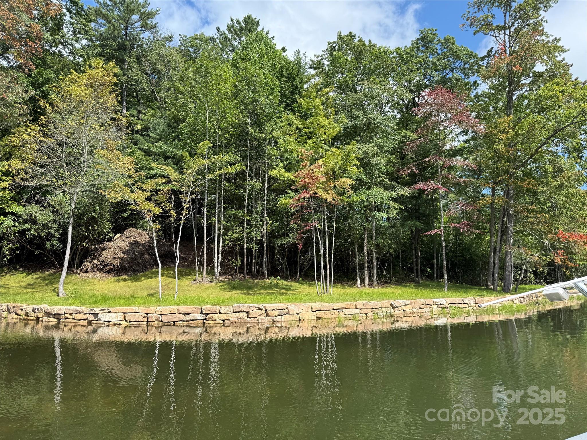 Two adjoining lake front lots on beautiful Lake Toxaway. Conveniently located near LTCC, golf course and marina and ready to build. Artfully crated seawall is in place including foundation for future boathouse. Engineered septic and building locations available for two lakefront homes. With 0.76 acre for one lot and 0.77 for the second we have a combined total of 1.53 acres with 300+ feet of lake frontage.