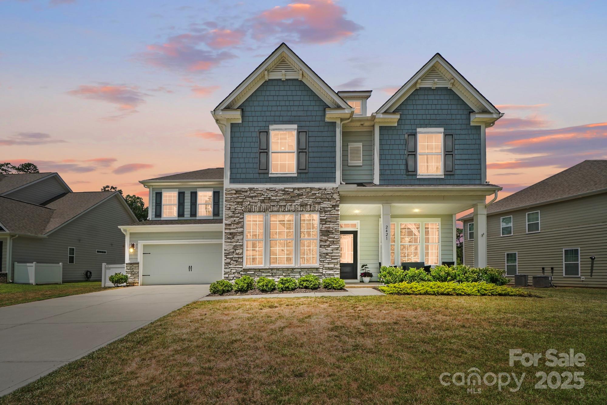 Sought-after Kristin floor plan—Cypress Point’s model home design—meets a premium setting and stylish upgrades. With no homes behind, enjoy seasonal lake views from the second floor. From the moment you step inside, you're greeted by coffered ceilings in the dining room and 15-lite French doors leading to a private office—setting the tone for refined comfort. The dream kitchen flows effortlessly into the living room, where oversized windows frame views of the fenced backyard’s striking stone fireplace and paver patio. The main level also offers a guest bedroom, full bath, and a bright breakfast area. Upstairs, the expansive primary suite features a spa-inspired bath and a massive walk-in closet. An epic bonus room provides space for everyone. Cypress Point delivers a true sense of community with its resort-style pool, pickleball courts, and holiday golf cart parades. Tankless water heater, irrigation, electric vehicle charger, Clover schools. This elegant home truly checks all boxes!