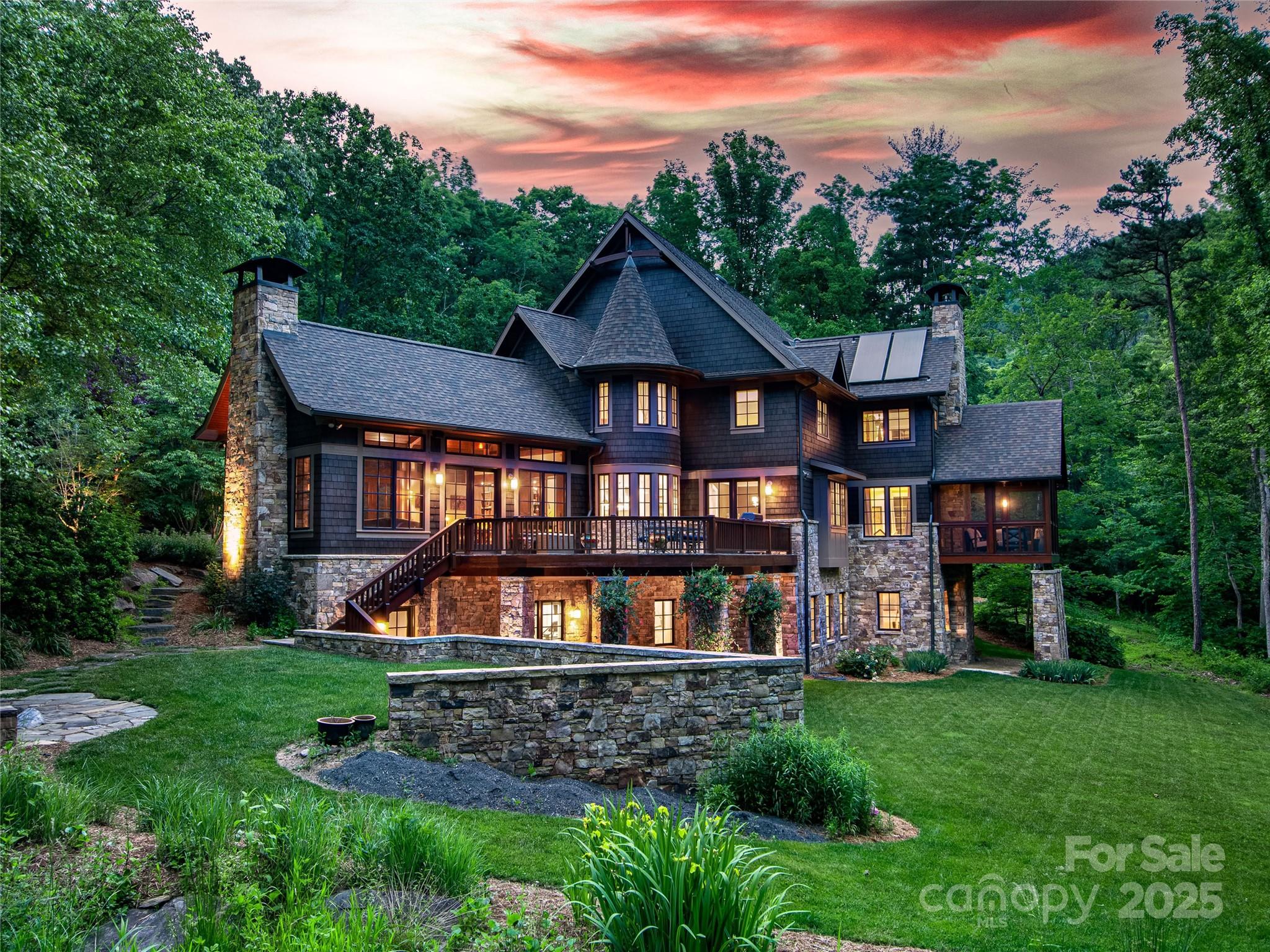 Discover the ultimate in luxury living with this stunning North Asheville masterpiece. Perfectly nestled in a mountain setting with a 95-acre conservation surrounding the mountains, the home blends timeless natural materials like Canadian red cedar shingles and regional stone with sustainable green technologies, including solar-assisted hot water and some radiant floor heating. Impeccable craftsmanship shines with over 5,000 board feet of reclaimed site lumber used for custom cabinetry, doors, and trim. Paired with luxurious finishes, premium appliances from Wolf, Sub-Zero, and Miele create a home of unmatched refinement. Designed for grand entertaining and family living, this home features two private offices, a home gym, and professionally landscaped outdoor spaces with a fenced backyard. Whether hosting under the stars or enjoying quiet mountain serenity, this residence offers elegance, sustainability, and unparalleled comfort.