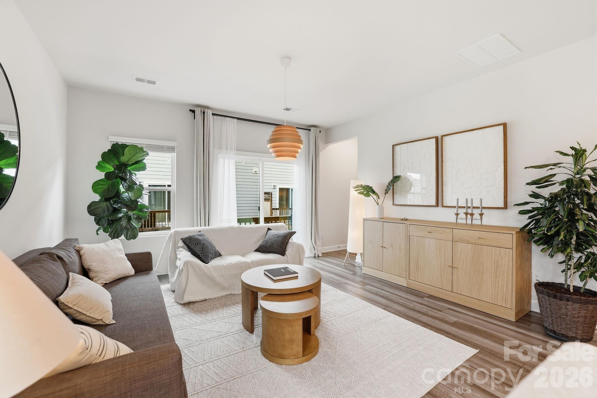 Welcome to this beautifully upgraded 4-bedroom, 3.5-bath townhome in the desirable City Park community, built by Meritage Homes in 2023 with the sought-after Distinct 1 finish package. Thoughtfully designed for modern living, this move-in-ready home offers stylish finishes, abundant natural light, flexible living spaces, and low-maintenance convenience just minutes from Uptown Charlotte.

Step inside to find an open-concept layout enhanced by extended upgraded EVP flooring throughout the first-floor entry and the entire main living level. The chef-inspired kitchen features elegant quartz countertops, a classic tile backsplash, 42-inch cabinetry, recessed lighting, and a Whirlpool stainless steel gas range with air fryer and convection functionality, making everyday cooking and entertaining effortless.

The spacious primary suite serves as a private retreat with crown molding and a beautifully appointed en-suite bath featuring a tiled shower surround. Upgraded tile flooring in all full bathrooms and the laundry room, oak stair treads, upgraded carpet in the bedrooms, and numerous builder enhancements add quality and style throughout the home.
Enjoy outdoor living from the covered front stoop or the rear deck, while the second-floor balcony offers an additional place to relax. Parking is a breeze with a two-car garage featuring a garage door opener, two dedicated parking spaces, additional open parking, and convenient on-street parking for guests.

Residents of City Park enjoy inviting community amenities including a gazebo, grilling area, and fire pit, perfect for gathering with neighbors or unwinding after a long day. Just minutes to the Charlotte Regional Farmers Market, Renaissance Park, Starbucks, Chipotle, and Panera.
With its premium upgrades, modern design, and exceptional location, this home offers the perfect blend of comfort, style, and convenience. Schedule your private showing today!