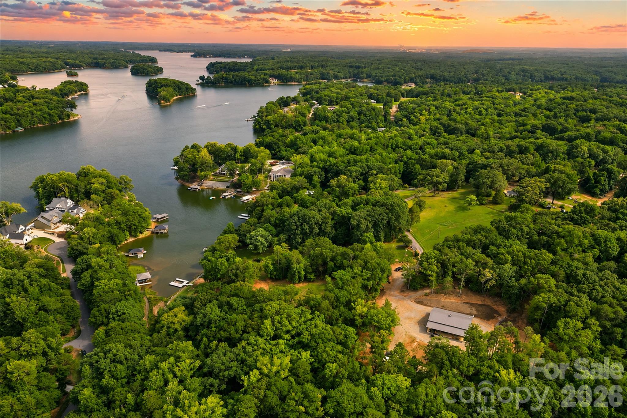 Some Lake Norman properties offer waterfront. Others offer acreage. Few offer both with the ability to begin enjoying the property immediately while creating a custom waterfront estate. Encompassing approximately 12.77 private acres across two adjoining parcels, this exceptional offering presents a rare opportunity to own an extraordinarily private Lake Norman property where much of the groundwork has already been completed and the next chapter is yours to create.

Tucked behind a gated entrance at the end of Whispering Winds Drive, the property unfolds across gently rolling, predominantly wooded acreage with established trails, a year-round creek, abundant wildlife, and approximately 213 feet of riprapped Lake Norman shoreline that transitions into a continuously flowing creek forming part of the property's boundary, with long water views and immediate access to the main channel. An adjoining subdivision common area provides an additional natural buffer, enhancing the property's privacy and preserving the surrounding setting. A thoughtfully cleared waterfront homesite has already been established, providing an ideal setting for a future custom primary waterfront residence while preserving the property's remarkable privacy and natural beauty.

Unlike purchasing raw waterfront land, this property can be enjoyed from the day you close. Completed in 2023, the newly constructed accessory residence offers approximately 700 square feet of heated living space featuring one bedroom, one full bath, and an open-concept kitchen, dining, and living area. Served by its own private well and septic system, the residence provides comfortable accommodations while plans for a custom waterfront home move forward.

Complementing the residence is an approximately 1,800-square-foot insulated garage and workshop designed for collectors, hobbyists, and outdoor enthusiasts alike. Finished with approximately 14-foot ceilings, two 12-foot overhead doors, polyurea epoxy flooring, Galvalume interior wall and ceiling finishes, custom cabinetry, utility sink, ice maker, propane ceiling heater, air compressor plumbing, overhead storage, and generous workspace, the building offers exceptional versatility. Additional improvements include covered lean-to storage, a storage building, concrete wash pad, and a 500-gallon propane tank.

The adjoining waterfront parcel further enhances the property's value with an active, transferable four-bedroom septic improvement permit already in place for the future primary residence. A private dock and boat lift (currently without electrical service) provide immediate access to Lake Norman while plans for the estate come to life.

With no HOA, no CCRs, exceptional privacy, existing infrastructure, and a rare combination of acreage, waterfront, and immediate usability, this property offers opportunities seldom found on Lake Norman. Whether enjoyed as a private retreat today or transformed into a custom waterfront estate over time, it provides the flexibility to create something truly lasting. Properties combining this level of privacy, acreage, waterfront, and future potential are increasingly difficult to replicate on Lake Norman.