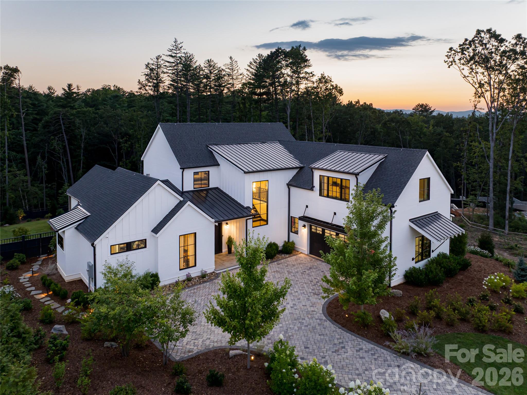 Immaculate and like new, this modern farmhouse in The Ramble Biltmore Forest offers a refined balance of timeless warmth and contemporary elegance. Crafted with exceptional quality, the four-bedroom, four-and-a-half-bath residence is designed to elevate everyday living with thoughtful detail throughout. Exposed beams, gracious proportions and an open-concept layout create light-filled interiors with effortless flow. The main-level primary suite is a private sanctuary with a spa-inspired bath and custom closet. Upstairs, a generous family room with bar invites gathering, while exceptional guest quarters, complete with kitchenette and private entrance, provide ideal accommodations for extended stays or multigenerational living. Outdoor living is equally compelling, with a screened porch featuring a fireplace and outdoor kitchen overlooking a manicured pool and privacy-fenced backyard, ideal for year-round enjoyment. Set on a quiet, no-through street near trails and parks, the home offers privacy and connection. Ownership in The Ramble grants access to an unparalleled lifestyle, including the Living Well Center with saline pool, fitness facilities and pickleball courts, historic Buck Spring Cabin for social gatherings, Longmeadow Park’s gardens and amenities, and more than seven miles of wooded trails. A residence where craftsmanship, community and enduring beauty converge.