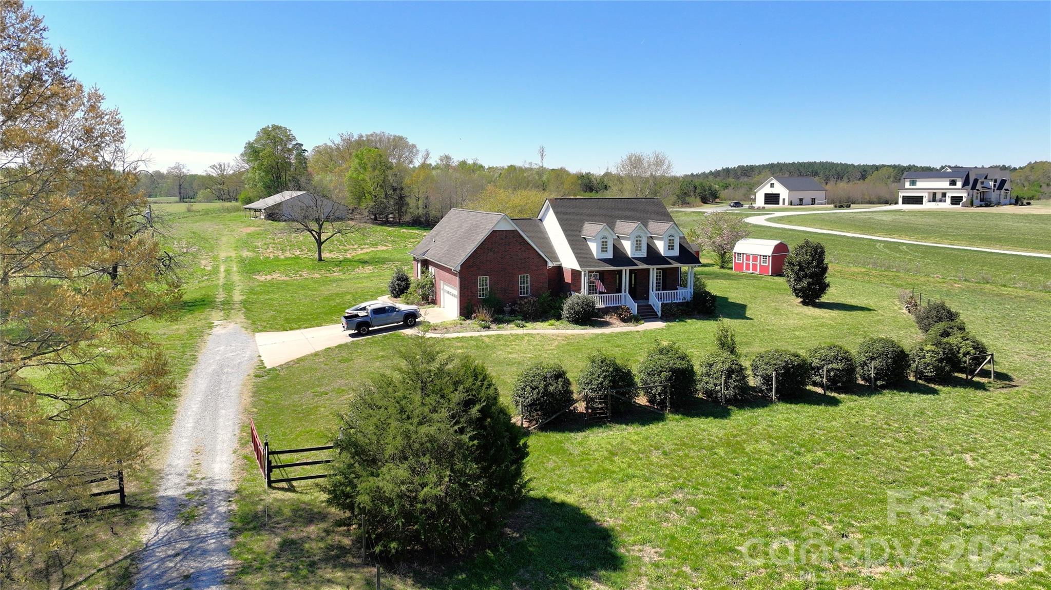 Welcome to your very own almost 7 acres in Marshville, NC! This peaceful country retreat is the best of rural living without sacrificing convenience. Just 5 minutes to downtown Marshville and under an hour to Uptown Charlotte, the location is as practical as it is picturesque. Featuring a beautiful brick single-family home with 3 bedrooms and 2 bathrooms alongside homesteading infrastructure, fenced land, and a gated driveway. A large barn accommodates up to 8 horse stalls, complemented by a fenced and gated side paddock, an additional 2 stall barn, and a spacious storage shed. The home boasts a large, open concept living area with incredible natural light, alongside a kitchen with tons of cabinets, spacious quartz countertops, and a cozy breakfast nook. Enjoy beautiful pasture views from the large, covered back and front porches, or throw a party on the oversized shaded patio! For over 10 years, the land has been lovingly and naturally maintained with animal impact. No pesticides, herbicides, fertilizers, or row crops here, making this a rare find for buyers seeking acreage ready for organic homesteading. The majority of these acres are green pastures perfect for grazing, with small pockets of wooded areas and large mature trees for shade. The street is quiet, the neighbors are friendly, and the property backs up to the open fields of a quaint tree farm. Opportunities like this do not come along often. Whether you are an equestrian enthusiast, aspiring homesteader, or simply craving space and clear skies at night, this property is ready for you to call it home!