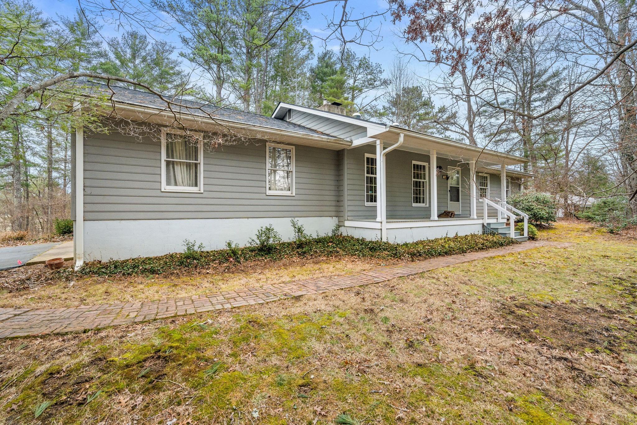 MULTIPLE OFFERS DUE MONDAY AT 5PM. Special Find in east Asheville with year round views of mountains and the pasture/barn of Warren Wilson College.  Easy access and minutes to Asheville and Black Mountain.  Loads of trails close by on Warren Wilson land. Wood floors in main living area and one bedroom.  Open concept from living to kitchen/dining area.  Wood stove in Kitchen area. Ductless heater in sunroom for year round use and mountain views. Very spacious garage with room for workshop.  Private and spacious yard.  Covered Wood Storage area. Home has been lovingly maintained over the years. Windows are double paned but not gas filled.  Roof is about 2 years old according to the owner. The college signed a road maintenance agreement in 2018 that says they will convey the ownership of the road to the lots on Daisy Hill March 2019 but none has been found. Do not walk on property without appointment.