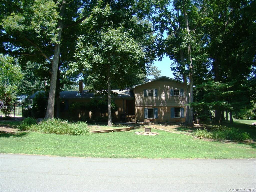 Full brick home w/large shade trees nestled in a mature, established n’hood just mins from I-85 & Concord Mills; Large ½ acre fenced yd w/storage sheds; No HOA -- bring your trailers, boats & RV’s! Replacement energy efficient windows; newer cabinets, stove & microwave; HVAC in 08’, WH in 10’; Nice rec room & heated/cooled workshop in lower level; Carport has been partially enclosed -- could easily be converted to garage or rec room; Deck off MBR; A little TLC could make this a great retreat