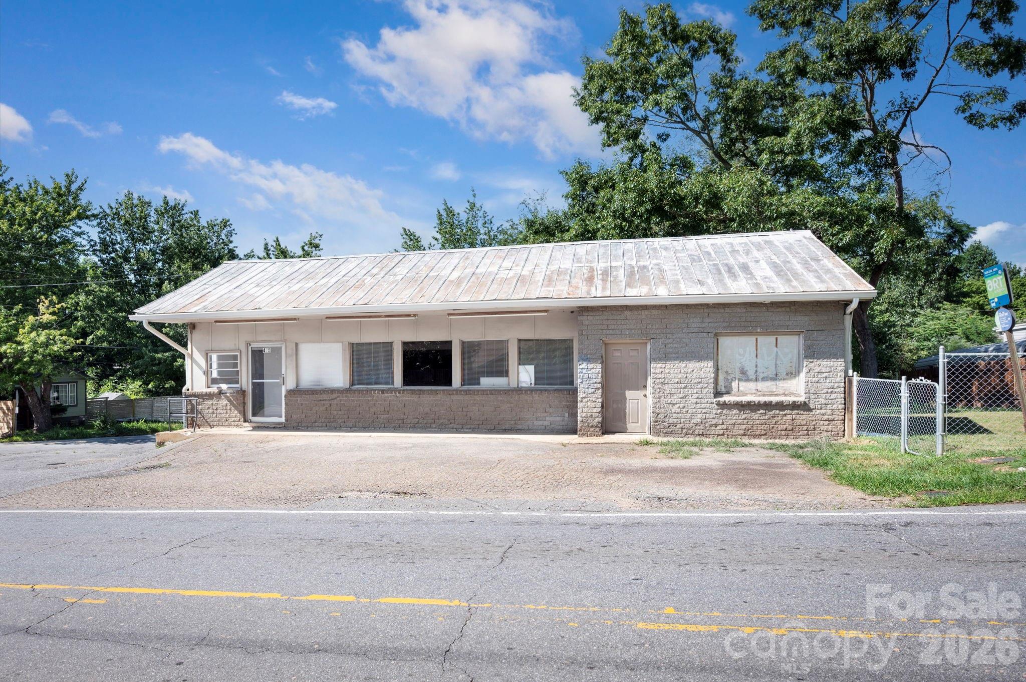 475 Deaverview Road presents an exceptional commercial opportunity on a highly visible corner lot in a convenient West Asheville location. Situated on 0.39 acres, this 2,219-square-foot building offers excellent exposure and easy accessibility. The flexible interior includes a kitchen, two half bathrooms, and adaptable spaces that may accommodate a variety of commercial or professional uses. Buyer to confirm all permitted uses, zoning, and occupancy requirements. The large yard provides potential for future expansion, additional parking, or the creation of an outdoor area, subject to applicable approvals. Ample off-street parking adds convenience for customers and employees. Whether you're looking to establish your own business or expand your investment portfolio, this property's prime location, visibility, and versatility make it an outstanding opportunity. Schedule your showing today to explore all that 475 Deaverview Road has to offer.