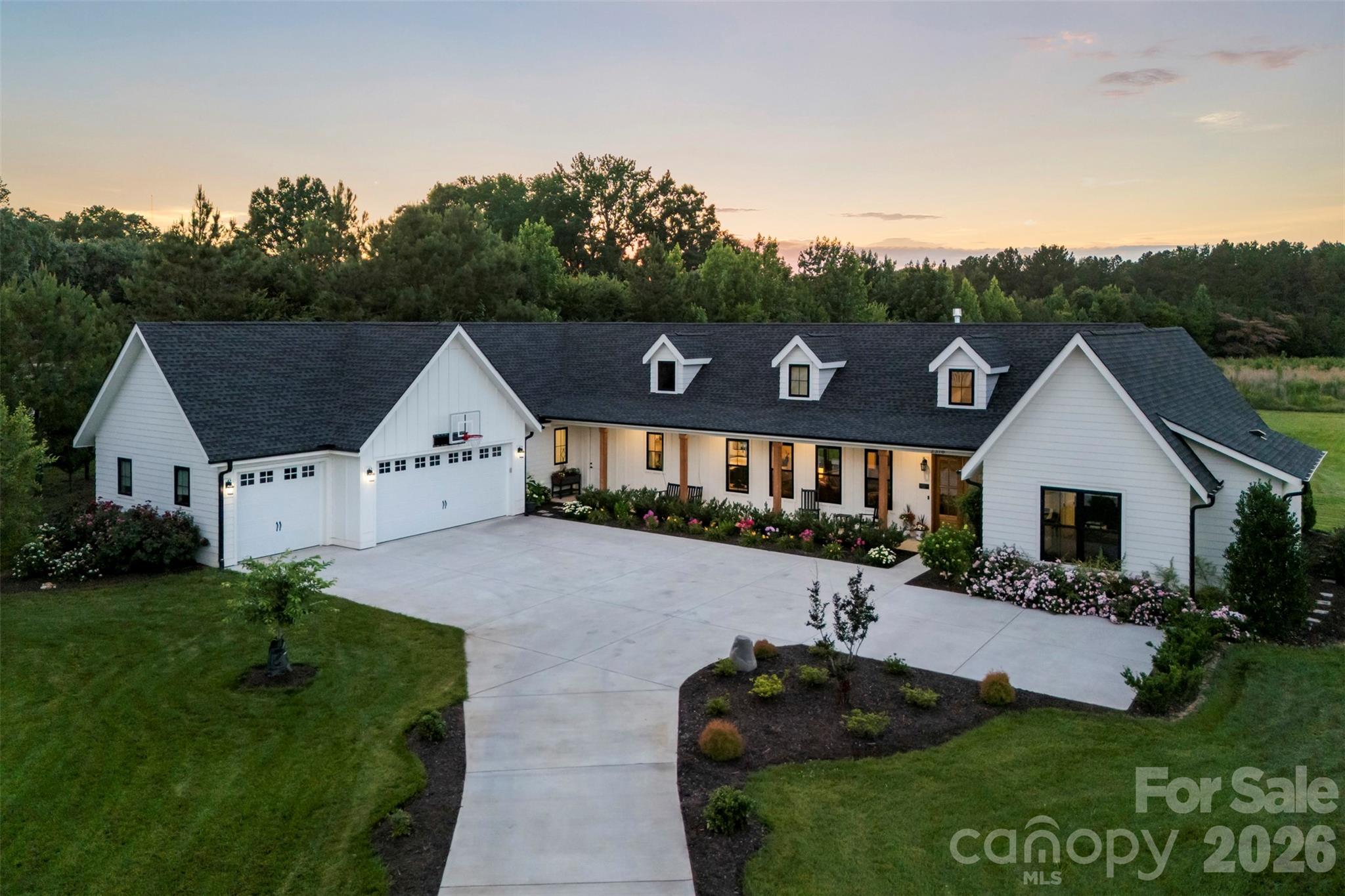 Welcome Home! Situated on 1.28 beautifully manicured acres, this stunning custom build 4-bedroom, 4-bath residence offers luxury living with every upgrade thoughtfully selected and completed in 2024. The long winding driveway offers ample courtyard parking. 
From the inviting rocking chair front porch to the designer upgraded finishes throughout, no detail has been overlooked. The open-concept floor plan features soaring ceilings, a chef’s kitchen with an oversized island, custom pantry, and spacious living areas designed for both everyday living and entertaining. 
The private owner’s retreat boasts a spa-inspired bath and generous walk-in closet. Two more bedroom with a Jack and Jill bathroom on the opposite side of the home invite guests with privacy. 
The fourth bedroom offers many flex options and includes its own full bathroom. From custom fit blinds throughout the home including automated power blinds in the in the Great Room, Owners Suite and bath and flex space/Fourth bedroom you will find every touch of this home was thoughtfully taken into consideration.
Enjoy year-round outdoor living on the expansive covered rear porch complete with a built-in outdoor kitchen, overlooking the professionally landscaped yard and fire pit gathering area. These outdoor amenities total 4,200 sq feet of indoor and outdoor living. 
Additional features include an oversized 3 car garage, designer bathrooms, and exceptional craftsmanship throughout.
A water softener system. 
Rinnai brand tankless water heater in the attic. 
Two AC units, one for each side of the house. 
13 zones of irrigation and drip line around the plant beds are all programmable remotely. 
Engineered hardwood flooring throughout the home 9.5” wide by 5/8” thick. 

 A rare opportunity to own a truly turnkey custom home that perfectly blends elegance, comfort, and privacy.