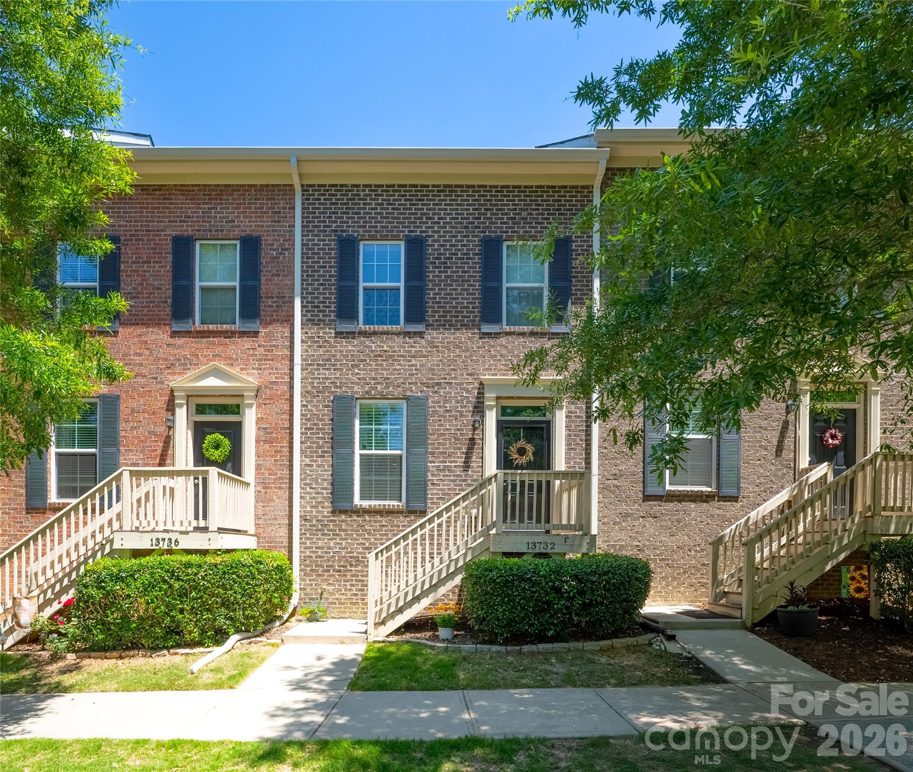 Enjoy low-maintenance living in one of Huntersville’s most desirable neighborhoods! This beautifully maintained brick-front townhome offers 2 bedrooms PLUS a versatile flex space across 1,676 square feet of thoughtfully designed living space. The main level features 9’ ceilings and an open floor plan that seamlessly connects the living, dining, and kitchen areas, creating an inviting space for both everyday living and entertaining. Warm wood flooring and upgraded lighting add character and enhance the home’s welcoming feel. The kitchen maximizes counter space and cabinet storage in a highly functional layout featuring warm wood cabinetry, granite countertops, tile backsplash, stainless steel appliances, and a breakfast bar. Soft-close cabinetry throughout the kitchen and bathrooms adds an elevated touch. Upstairs, both bedrooms are generously sized and feature private ensuite bathrooms. The primary suite includes a walk-in closet, double vanity, and a large tub. Laundry is conveniently located on the upper level, and the washer and dryer are included. The lower-level flex space offers endless possibilities—perfect for a home office, gym, media room, playroom, or creative studio. An oversized 1-car garage provides ample storage space, with additional parking in the driveway and on-street parking on Cinnabar Place. Seller is offering a 1-year home warranty for added peace of mind. Vermillion is a charming, well-maintained neighborhood with tree-lined streets, sidewalks, and an impressive array of amenities, including two pools, playgrounds, parks, walking trails, a community garden, and a neighborhood restaurant. Located just a 15-minute walk (or short drive) from downtown Huntersville, with convenient access to Charlotte and the Lake Norman area.