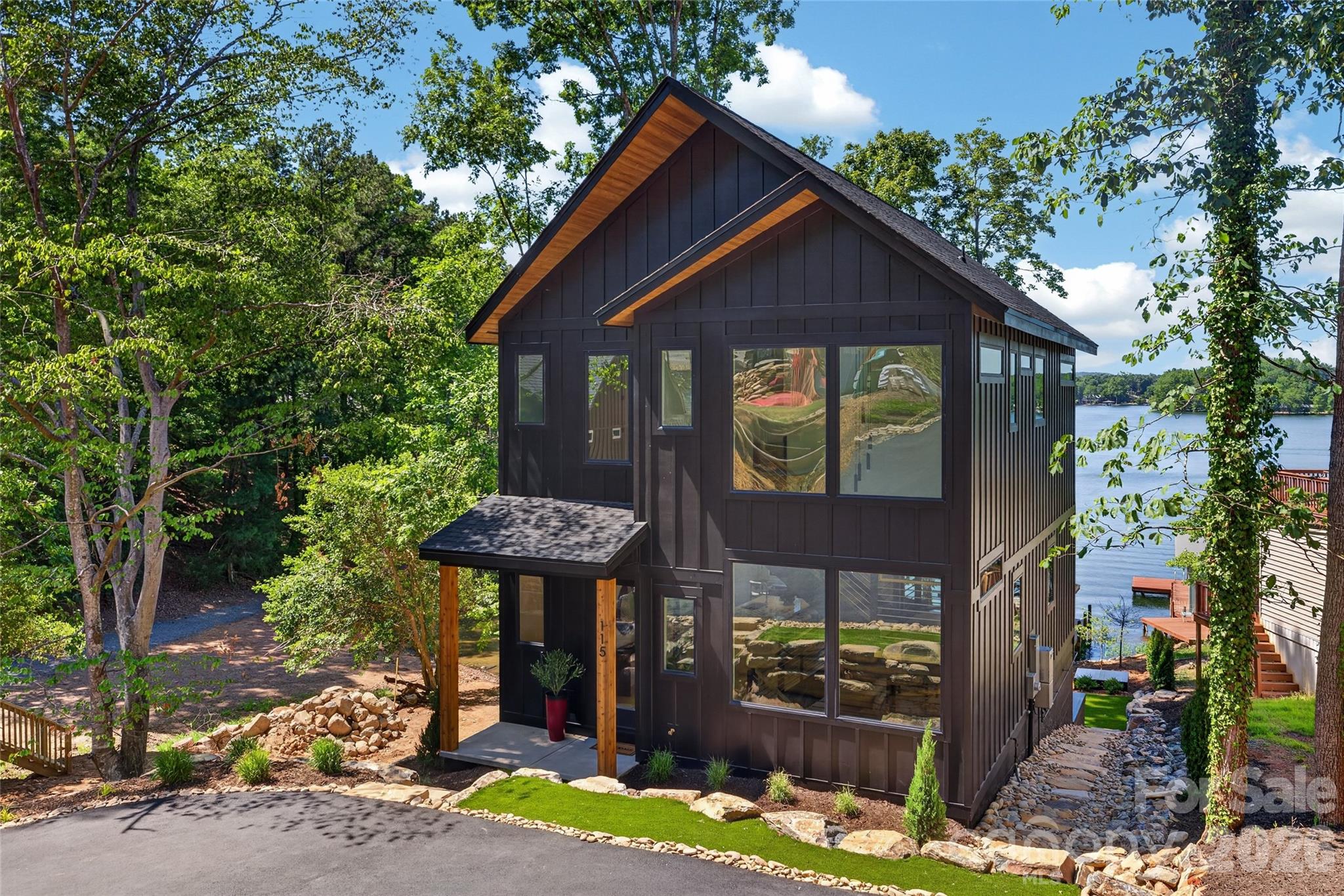 Experience refined lakefront living in this stunning new construction home on Lake Tillery. Designed with striking transitional modern architecture, this waterfront retreat blends clean lines, warm finishes, and thoughtfully curated details throughout. Perfectly positioned on a flat lot with exceptional water views, the home offers seamless indoor-outdoor living and an open, light-filled floorplan ideal for both everyday living and entertaining. Expansive windows capture the beauty of the lake from multiple living spaces, while the modern design creates a sophisticated yet inviting atmosphere. Enjoy the best of lake life with easy waterfront access, beautiful views, and brand-new construction. A rare opportunity to own a stylish, modern waterfront home on Lake Tillery. Listing agent is owner.