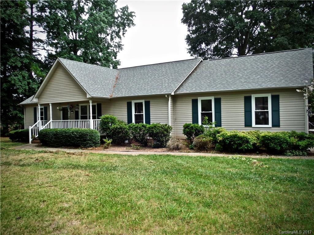 Great 3 bedroom 2 bath home on spacious lot in the rapidly growing Rock Hill area!  The house is nestled on a BEAUTIFUL FENCED WOODED LOT WITH POOL, attached two car garage & a detached one car garage that can be used as a workshop. Features include HARDWOODS in living and dining, SPACIOUS KITCHEN, ceiling fans throughout, covered front porch & screened back porch off kitchen.  New windows installed in 2013, hot water heater replaced in 2014, brand new pool pump.