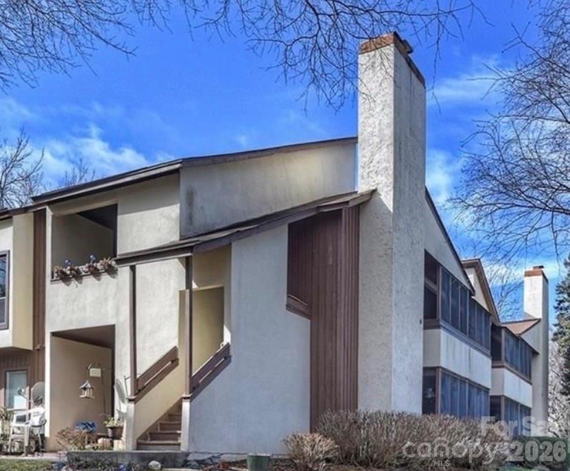 Located in the established Brandywine community in East Charlotte, this 2-bedroom, 2-bath condominium offers 1,132 square feet of living space and was originally built in 1982, featuring a top-floor position with water views of the community lake. The layout includes two spacious bedrooms with a primary suite offering an updated walk-in shower, a full secondary bath accessible from the main hall, and a large central living area connected to a private screened balcony overlooking the water. Interior finishes include hardwood flooring, carpeted bedrooms, granite countertops, tile backsplash, and ample storage throughout, along with a wood-burning fireplace and in-unit laundry with washer and dryer included. The unit is situated in a wooded, established condo community with mature landscaping, and offers convenient access to Albemarle Road, Independence Boulevard (US-74), and nearby retail, dining, and commuting routes into Uptown Charlotte.