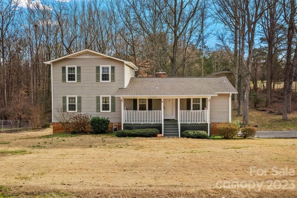 From the rocking chair front porch to the inground pool, this home situated on almost an acre in Rock Hill, SC is ready for you to come home. This home features hardwood floors, a large living room with a gorgeous stone gas log fireplace, and kitchen with breakfast nook and an unfinished basement. The primary bedroom on the main floor features an ensuite bathroom. Enjoy access to the screened in porch through the family room or primary bedroom. Upstairs two bedrooms share access to a full hall bathroom. Located near Lake Wylie, this home is in a great location to enjoy all the perks of country life while being close to local amenities and conveniences.