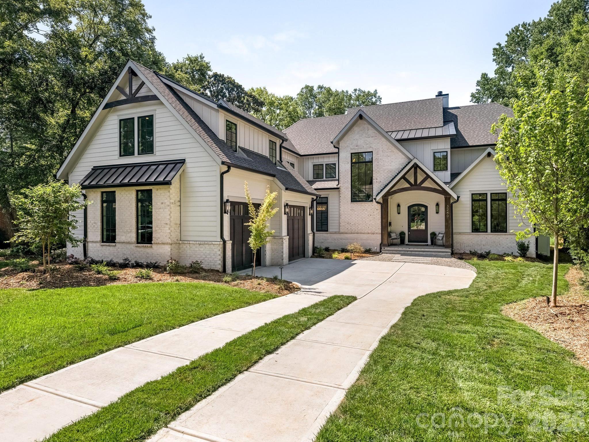This exceptional new two-story custom home blends contemporary design with timeless warmth on one of Charlotte's most desirable locations on a beautiful tree lined street in Sedgefield.  Designed with both luxury and livability in mind, the home features expansive open-concept living spaces, curated designer finishes, and beautiful white oak accents throughout.  At the heart of the home is a chef's kitchen with high end appliances and custom cabinetry that flows seamlessly into the eat-in breakfast nook and light filled living space.  Large sliders lead to a covered rear porch with a gas fireplace, creating an effortless connection between indoor and outdoor living.  The thoughtfully designed floor plan includes five bedrooms, five and a half bathrooms, a private office, loft, and bed/bonus room.  The spacious primary suite offers a spa-inspired retreat with stunning tilework, a coffee nook, closet laundry connections, and elevated finishes. A well-appointed mudroom with built-ins and a desk/drop zone adds practical organization just off the oversized two car garage.  The home is very energy efficient - with foam insulation in the attic and a sealed, encapsulated crawl space with a dehumidifier.  It is just minutes away from uptown, several parks, and a plethora of restaurants!   Your next home awaits!
