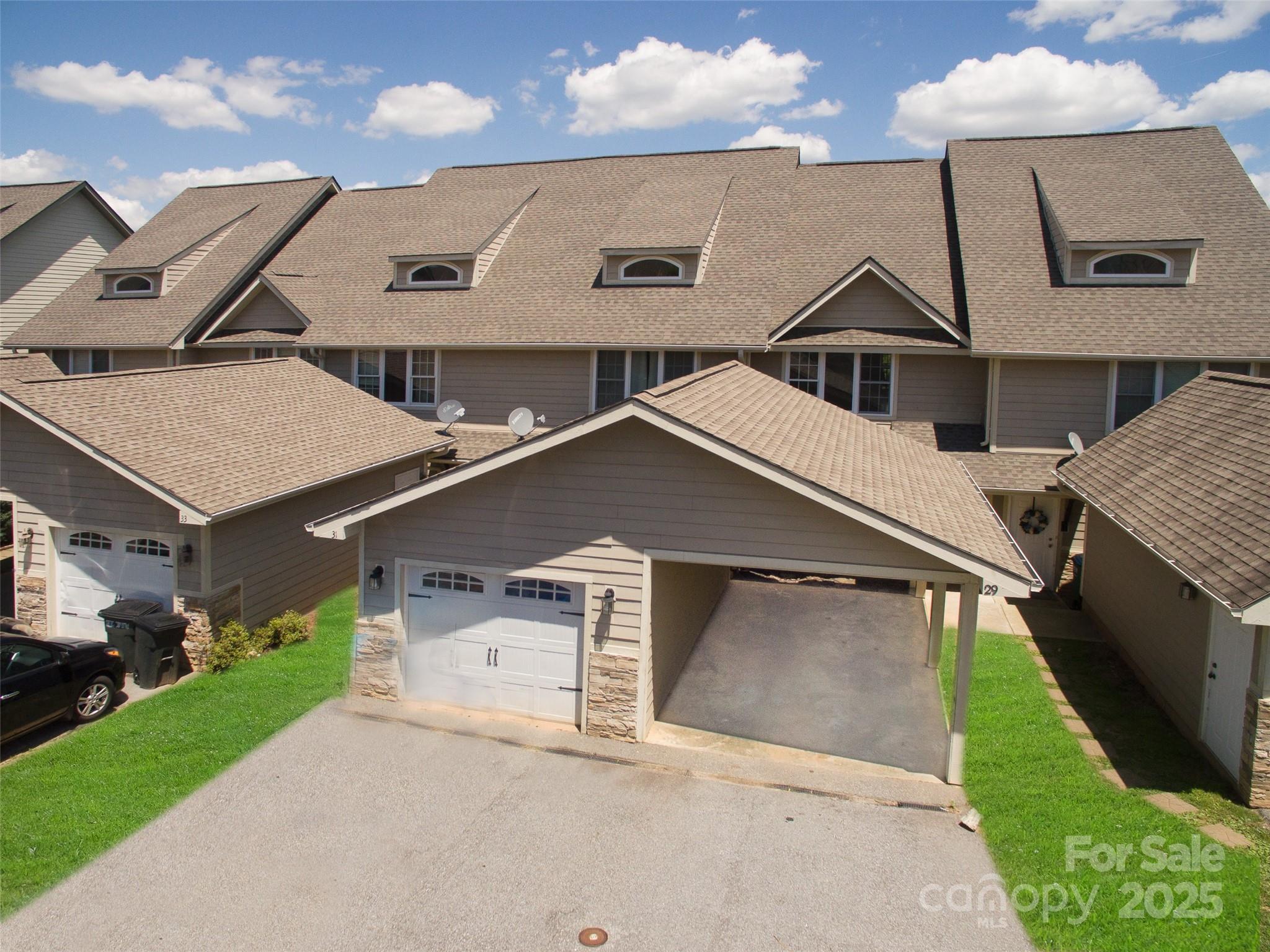 From the moment you step in this 3 Bedroom, 3 Full Bath contemporary townhome, you are encompassed with the panoramic mountain view! The main level offers granite countertops, updated cabinets, eat-in kitchen, stainless appliances, laminate wood flooring, dining area, gas fireplace with entertainment area and deck with panoramic view of layered mountains. Upper level offers primary en-suite with walk-in closet and deck with views. Lower level offers bedroom, bath and family room/media room, laundry/utility area and patio with separate entrance. Attic storage also. Freshly painted interior. Community pool, dog park, and clubhouse, yard and road maintenance. Low HOA dues. Approx 10 mins to Downtown Asheville. City convenience with county taxes! Enjoy living in the mountains with its open space while only minutes from shopping, dining, and medical facilities. Lots of space and great outdoor living!! A MUST SEE
