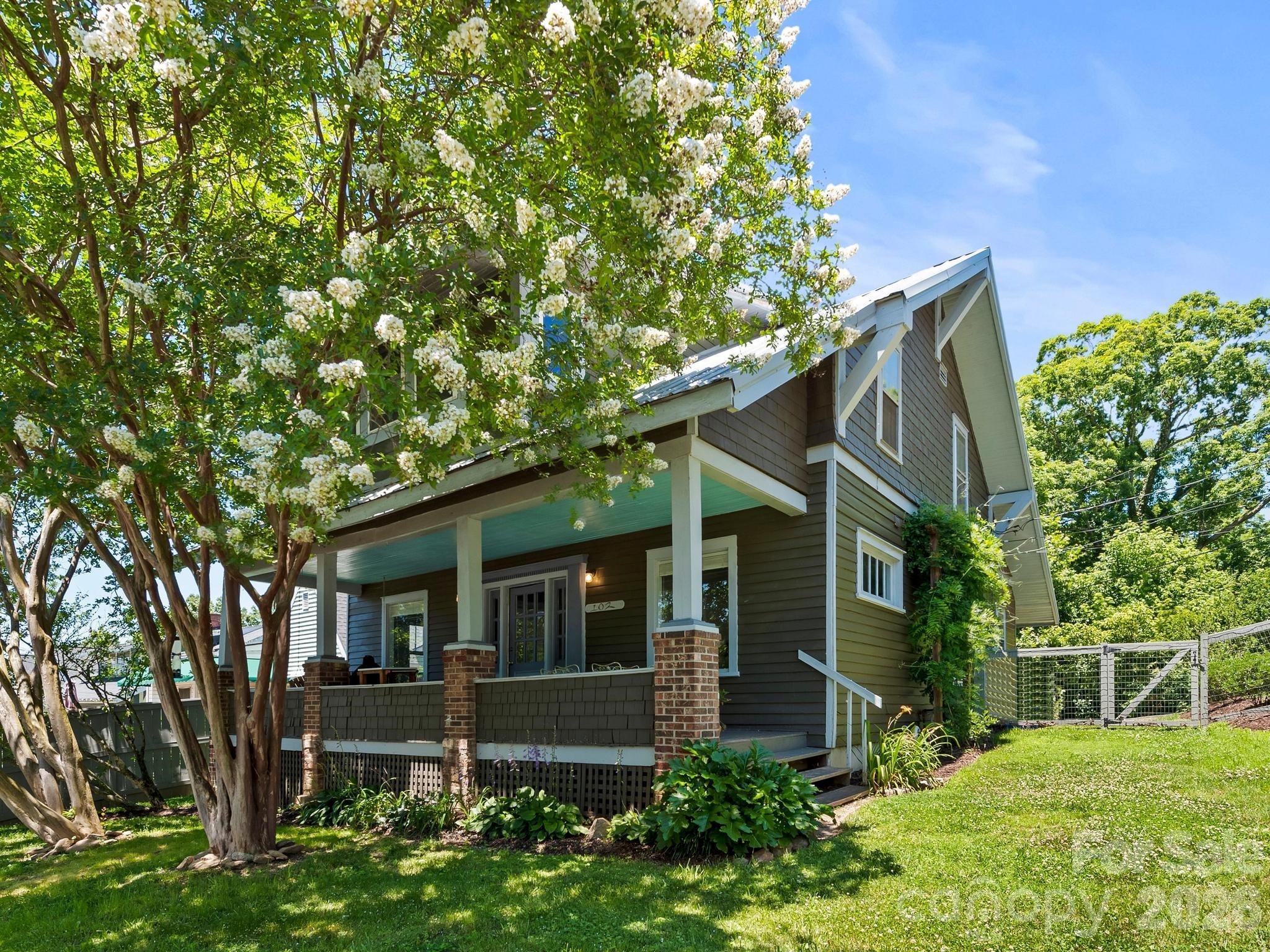 Montford is known for its historic homes, and this 1913 Arts and Crafts duplex fits right in, just down the street from All Day Darling and an easy walk to downtown Asheville. The kind of address you build your whole day around. The main-level unit lives like a home of its own. Hardwood floors run through a renovated kitchen with a gas range, island, and breakfast bar, opening to a dedicated dining room and a living room warmed by a wood stove. Two bedrooms (one easily a home office), two full baths, laundry, and a full basement for storage round it out. Upstairs, the second unit has its own private entrance and the same easy livability: a bright living room with big windows and shady Montford views, hardwood floors, a kitchen with a large pantry and breakfast bar, two bedrooms with a walk-in closet, a full bath, and its own laundry. The home fronts two streets, with off-street parking and the everyday entrance around back, plus a fenced yard, both rare and welcome this close to town. Each unit is separately metered for gas, electric, cable, and internet; only water, sewer, and trash are shared. Two new natural gas furnaces from 2023, a metal roof in great shape, and no HOA make this one as sound as it is charming. Live in one and rent the other, or hold both. Either way you're in one of Asheville's most walkable neighborhoods, where summer Shakespeare in the Park, your morning coffee at All Day Darling and downtown Asheville are all just down the street.