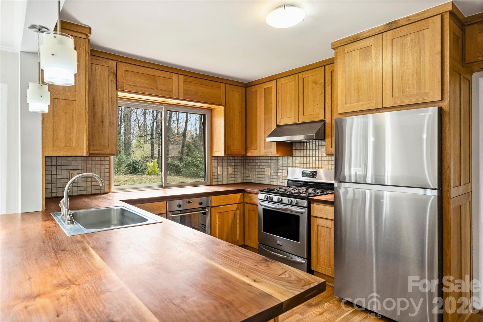 Freshly painted, popcorn ceilings removed and new poly in the crawl space create a welcoming home that is ready to be yours! Fig tree, peach trees and blueberry bushes are mature and fruit bearing! The kitchen cabinets are custom built on site and made of white oak with gorgeous solid walnut custom built countertops. One bathroom has a custom built walnut vanity and the other has a custom built hickory cabinet and vanity. New flooring in the rec room. Almost a 1 acre lot with plenty of space to add a pool! This home has been meticulously maintained. The neighborhood is quiet and offers lots of privacy. Chimneys being sold in "as is" condition; no known problems.
