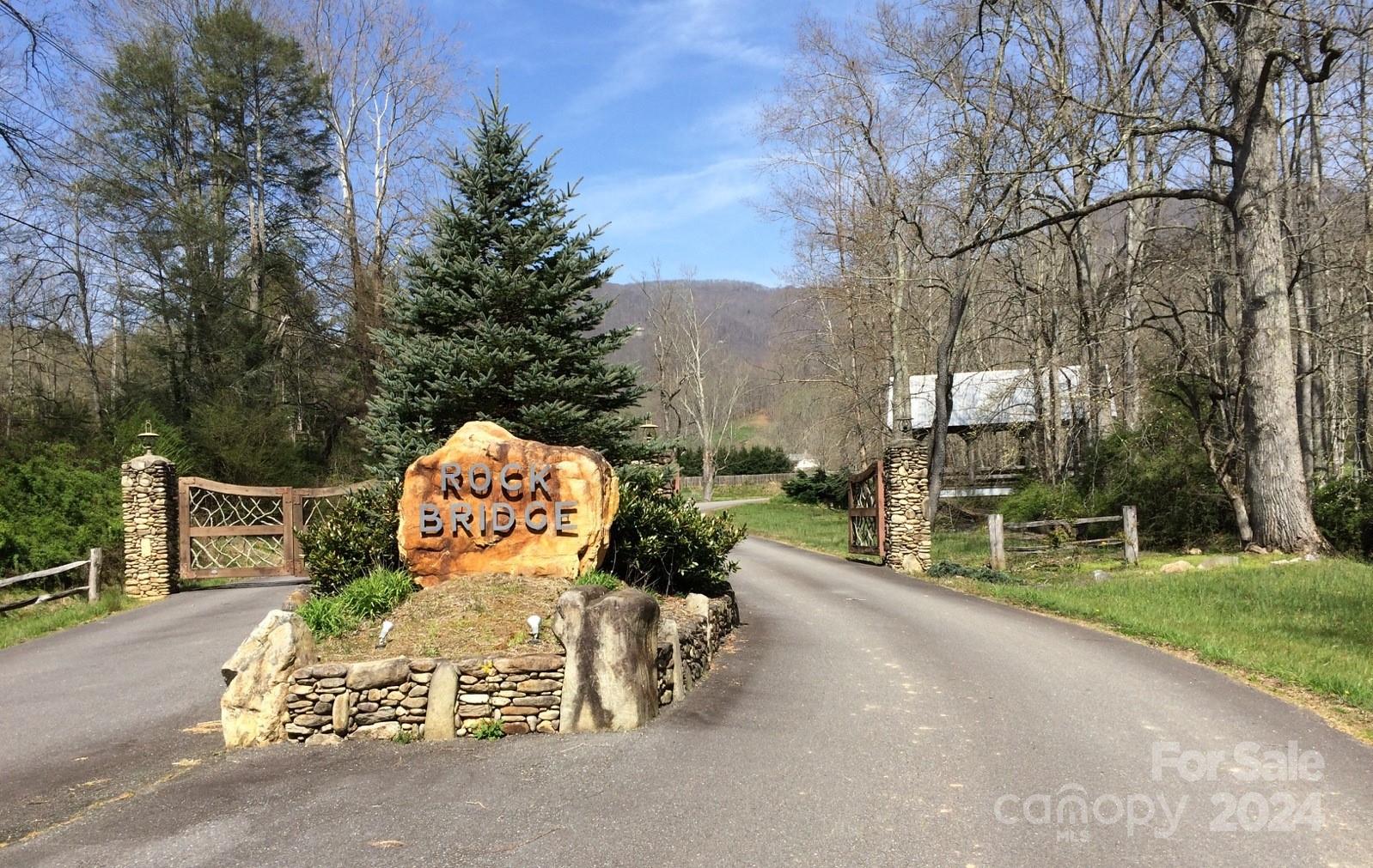 2/3-acre lot with great views in the gated community of Rock Bridge. Driveway and partial building pad are cut in. Priced to sell at $50,000. City Water, Buried utilities, wide paved roads, well maintained subdivision. Close to both Waynesville and Maggie Valley.