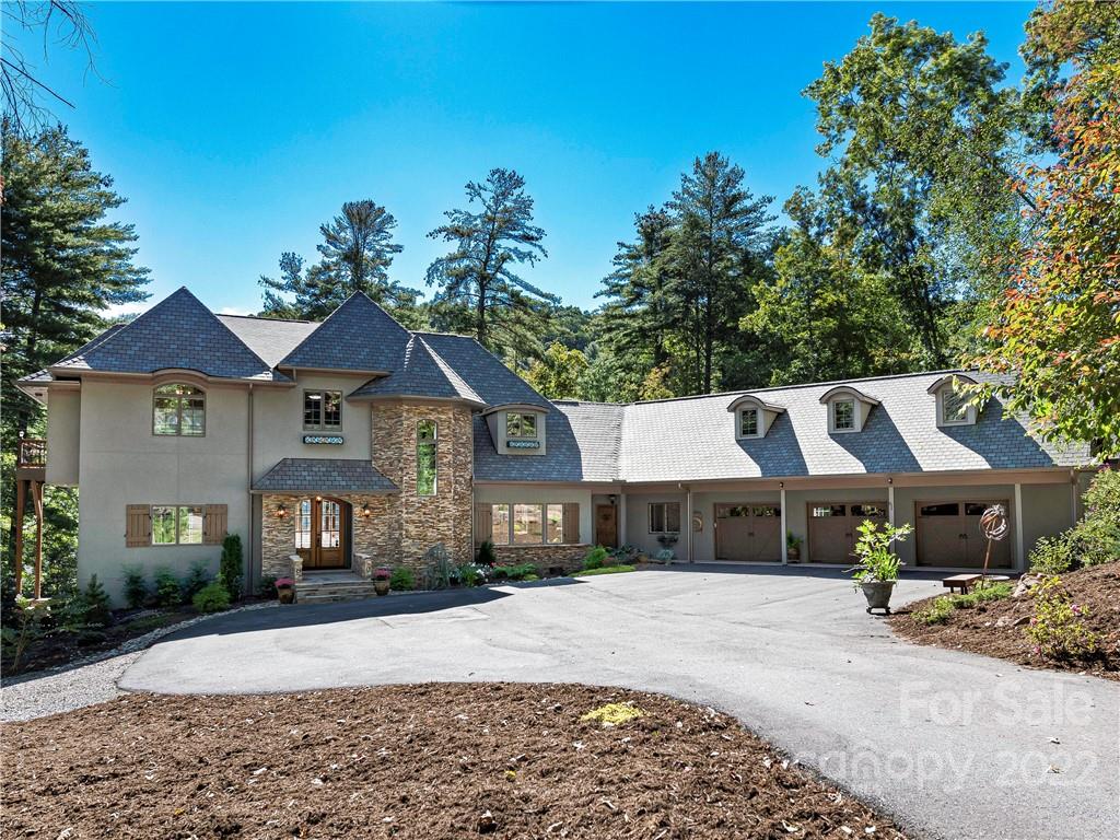 Enjoy beautiful sunrises and an abundance of natural light in this private, low-maintenance home in The Cliffs at Walnut Cove. Recently updated throughout, it features a completely renovated kitchen, new primary suite on the main floor, and mudroom/laundry room. The chef’s kitchen showcases professional level SS appliances and induction cooktop. A second primary suite upstairs features walk-in closets and nearby sitting room/office and additional laundry room.  An elevator provides easy access to all floors, including two additional bedrooms, family room and bonus room on the lower level.  This home is perfect for entertaining with the large in-ground saltwater pool, and outdoor kitchen.  Abundant storage throughout the house, three-car garage and plenty of extra parking. The nearby babbling stream adds to the ambience in the large, fenced backyard. Close to Walnut Cove’s trail system and the state-of-the-art Wellness Center with pools, tennis courts, and more. Membership Available