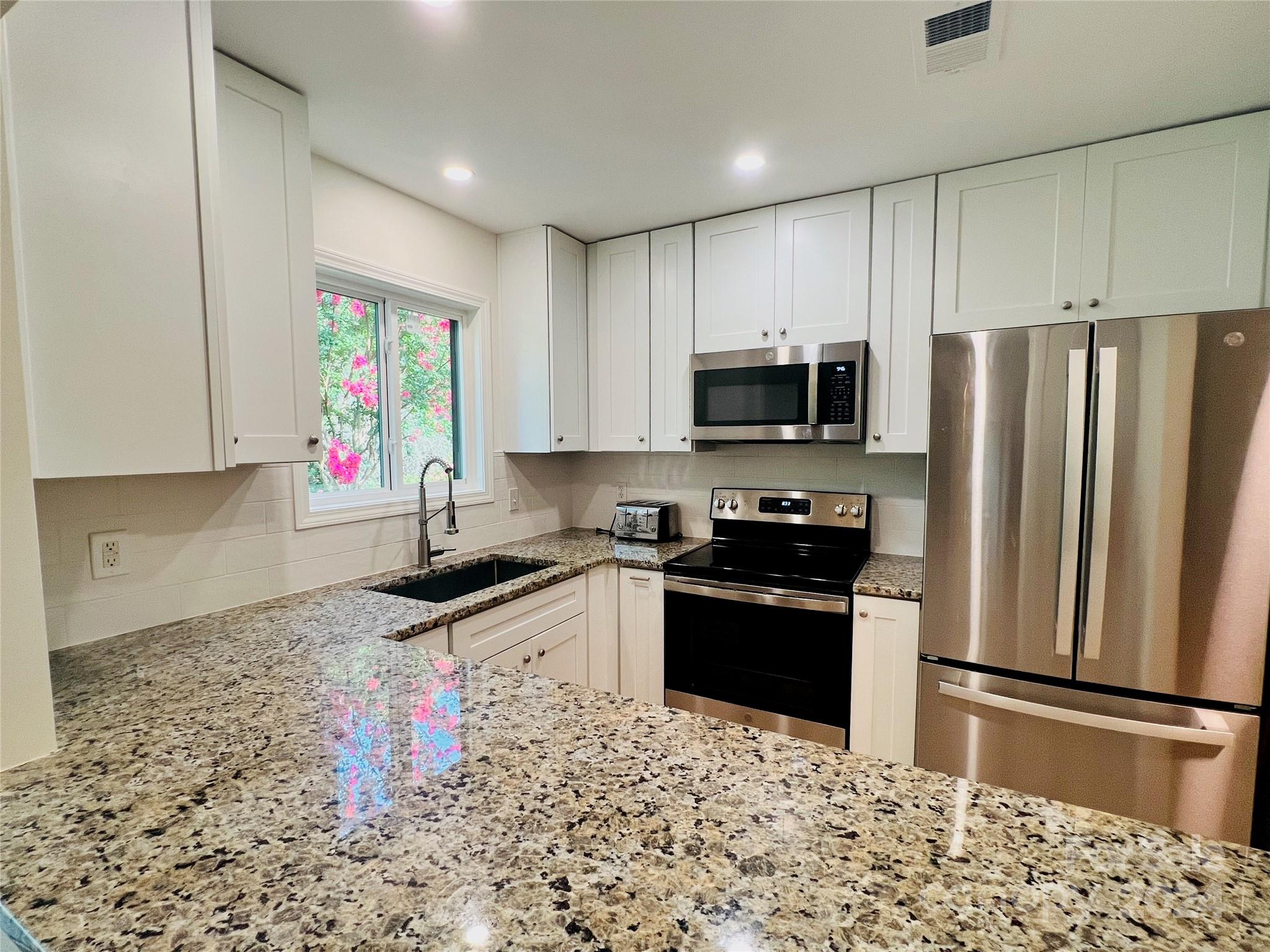 Fully renovated (Completed May 2024) main level condo located on the desirable Brawley Peninsula. Bright & open FP w/new Stainmaster LVP floors. Popcorn ceilings have been removed, all walls, ceilings & trim have new paint. New custom cabinets installed in the kitchen complete w/granite countertops, stainless steel farmhouse sink & New Moen plumbing fixture. New stainless steel GE Range,Microwave & refrigerator w/ice maker & water dispenser. KitchenAid dishwasher came with/home. The opening between the kitchen & Dining/Great Room has been expanded. New Whirlpool stackable washer/dryer. Both bathrooms have been renovated w/new tile floors, new cabinets, granite countertops, new toilets, bathtub (Kohler), tiled shower, sinks (Kohler), Moen fixtures & new mirrors (primary dual sink vanity). Spacious bedrooms w/built-in closet systems. New recessed lighting, ceiling fans & fixtures throughout the interior. Two new patio slider doors w/built-in blinds. Two covered porches w/beautiful views.