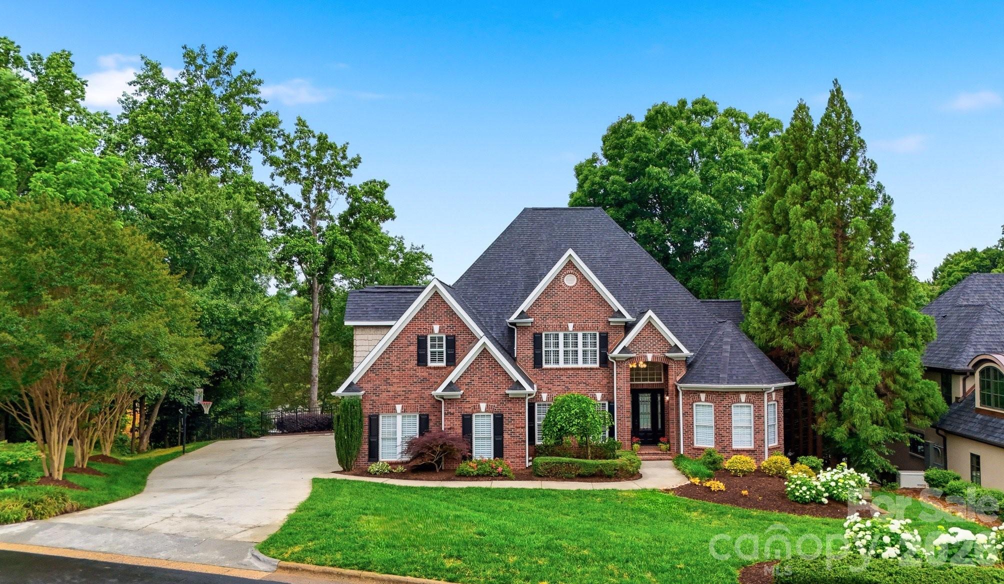 Experience the very best of Lake Hickory in this exceptional waterfront home where luxury feels comfortable, inviting and easy to enjoy. Situated in prime NW Hickory, this property sits on 135 feet of lakefront with covered dock, boat lift and jet ski ramps. Inside, you'll find a two-story foyer opening into a two story great room with fireplace surrounded by custom built-ins, where expansive windows frame peaceful lake views and radiate tons of natural light throughout the home, flowing seamlessly into the gourmet kitchen with oversize island and dining area. Main level highlights include a spacious office, formal dining, primary suite w/sitting area, large walk in closet and a spa feel en-suite bath. Main level laundry/mudroom adds convenience. Upstairs offers 3 large bedrooms, a bonus room,2 full baths and 2nd laundry for easy living. The finished basement provides even more room for entertaining and enjoyment, complete with a second living area/rec room with stone fireplace, full kitchen, separate theatre room, bedroom, full bath, a custom built secured safe room and abundant storage spaces. Outdoor amenities allows you to have quiet afternoons or lively gatherings around the heated saltwater pool. A spacious patio with outdoor stone fireplace and built-in grill/island w/beverage refrigerator, transforms the property into a true resort style retreat. Designed with both, everyday living and entertaining in mind, this property is located just minutes away from downtown Hickory, schools, medical facilities, shopping and dining adding unmatched convenience