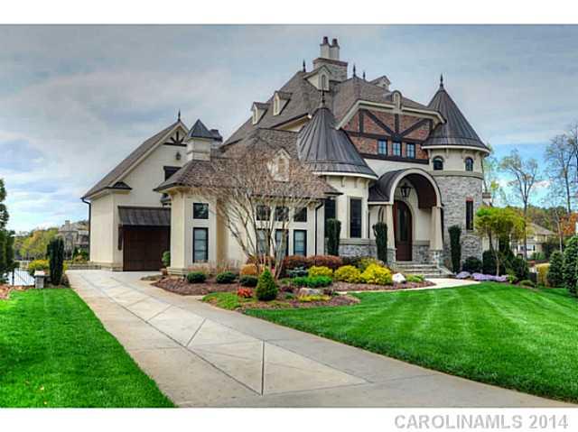 Waterfront custom home w/understated elegance at every turn.  Old World charm meets seamlessly to create perfect lakeside retreat.  Each room adorned with the finest custom details, walnut HW on main, 100% wool carpet, new Currey & Co chandeliers, imported reclaimed French tile, marble and granite countertops, large master w/ rotunda sitting area, Chef's kitchen w long range lake views and sunset