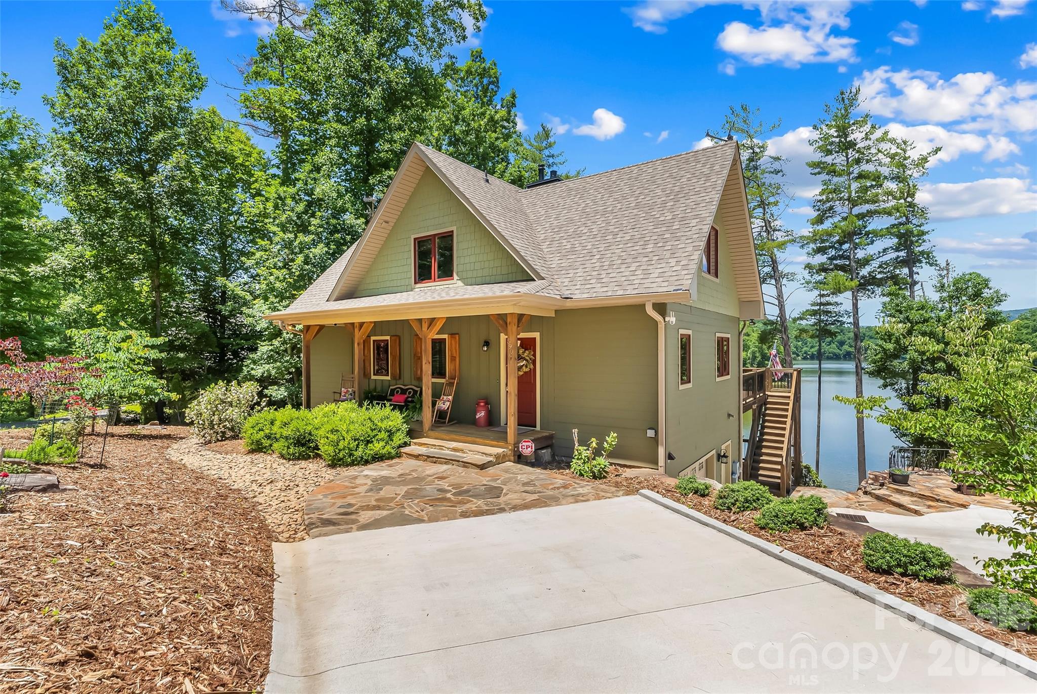 Welcome to lakefront living in this beautifully maintained 3 bedroom, 3.5-bath home nestled on a waterfront lot in a quiet cul-de-sac.  Offering the perfect blend of comfort, functionality, and outdoor enjoyment, this property is designed to make the most of its stunning lake setting. The main level features a spacious primary suite, providing convenient one-level living, along with warm hardwood floors that flow throughout the living areas. The living room centers around a gas log fireplace, creating a cozy gathering space year-round. The kitchen is thoughtfully designed with an island for meal preparation,  the adjacent dining area is perfect for casual dining, while the nearby laundry room adds everyday convenience. Step outside to the covered rear porch and enjoy peaceful mornings overlooking the water or unwind in the evening as the sun sets across the lake. Upstairs, you'll find two additional bedrooms, a hall bath, and a versatile loft area perfect for a home office, reading nook, or additional living space. The finished lower level expands the home's functionality with vinyl plank flooring, a spacious family room featuring a wood-burning stove, a full bath, and a fourth room ideal for guests. A one-car garage with workshop area provides ample space for hobbies, storage, and lake gear. Outdoor living is where this property truly shines. Enjoy lake views from the lower-level deck, gather around the fire pit with custom railings or head down to your private. 2 slip (one covered, one uncovered) dock for boating, fishing, and endless days on the water. The concrete driveway offers easy access and low-maintenance convenience. additional home features include whole house generator, both tank and on demand water heaters and security system.  Located in a desirable gated community with amenities including a picnic pavilion and walking trails, this home offers a peaceful retreat while remaining just 15 minutes from downtown Marion's dining, shopping, and conveniences. Whether you're seeking a full-time residence or a weekend getaway, this waterfront property delivers the lake lifestyle you've been dreaming of.